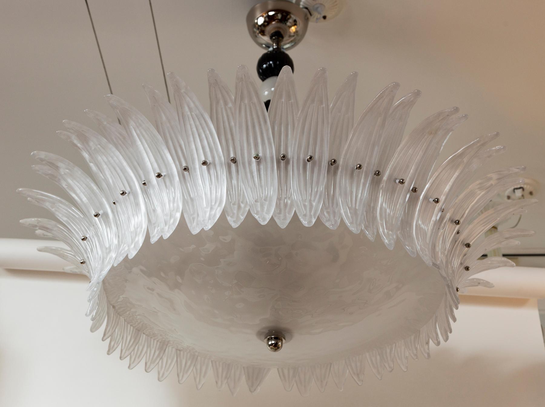 A large nickel polished ceiling fixture comprised of a glass blown dome shaped glass dish surrounded by 60 opaque white blown palm leaves and suspended by a central stem adorned with black and white balls.

Sold as electrified to US code with 6