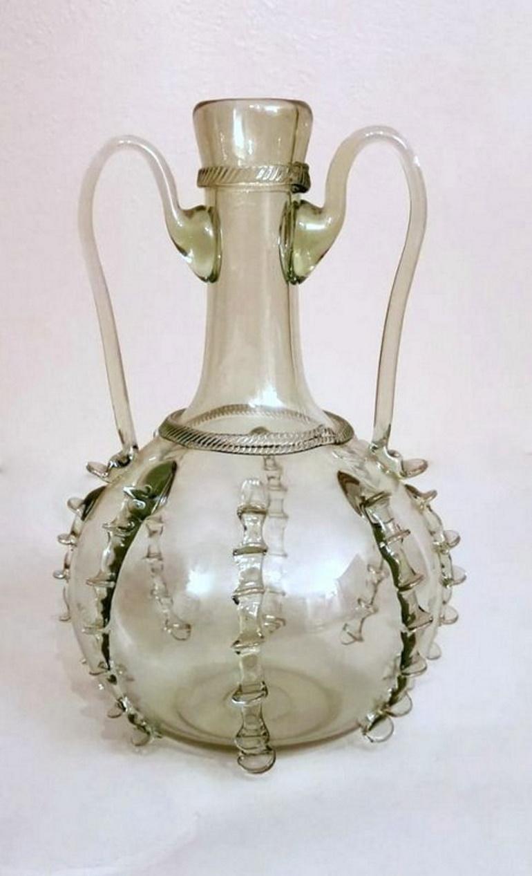 Delightful blown sodic-calcic glass bottle; it was made by a Murano glass master between 1950 and 1952 who was inspired by an early 18th century model preserved at the Murano Glass Museum, creating it with the same ancient techniques; from molten