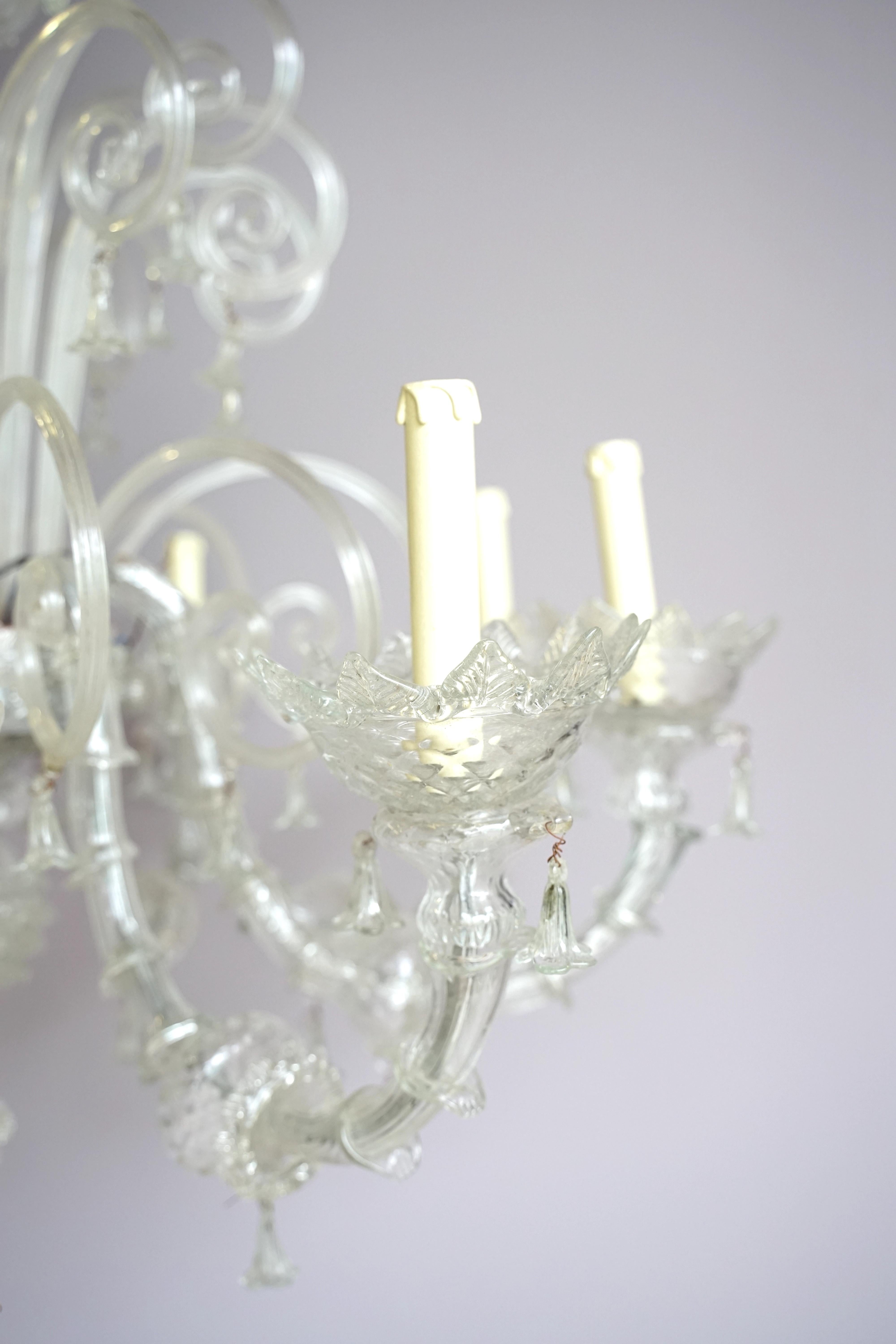 Interesting and particular Murano blown glass chandelier, with 10 lights.  As can be seen, it is not the classic coloured Venetian chandelier, but is embellished with many pastorals, i.e. the stems that take their name from the symbolic staff, with