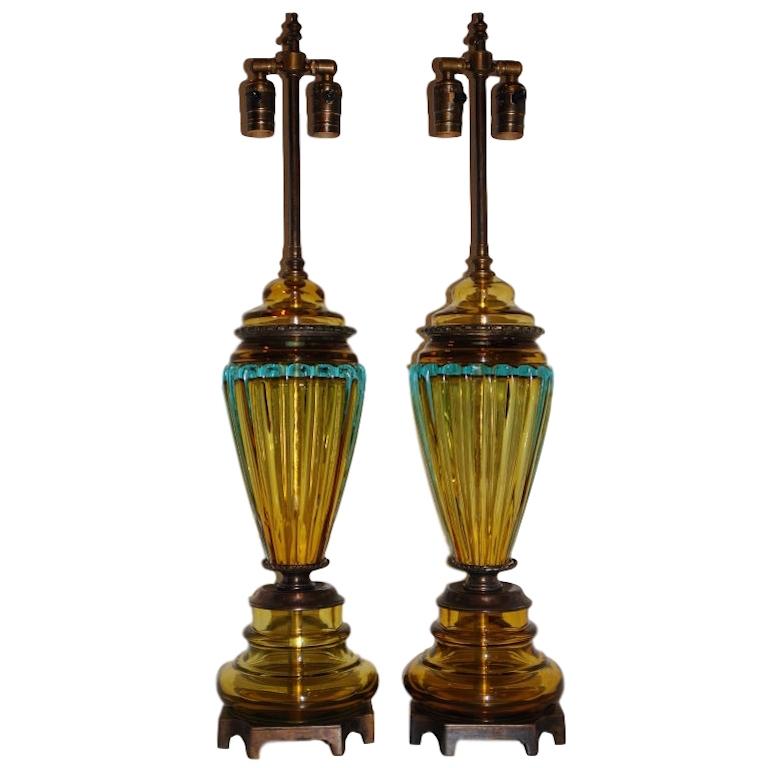 Pair of circa 1920s Italian hand blown and molded glass in yellow blue and green hues on bronze bases.

Measurement:
Height of body 32