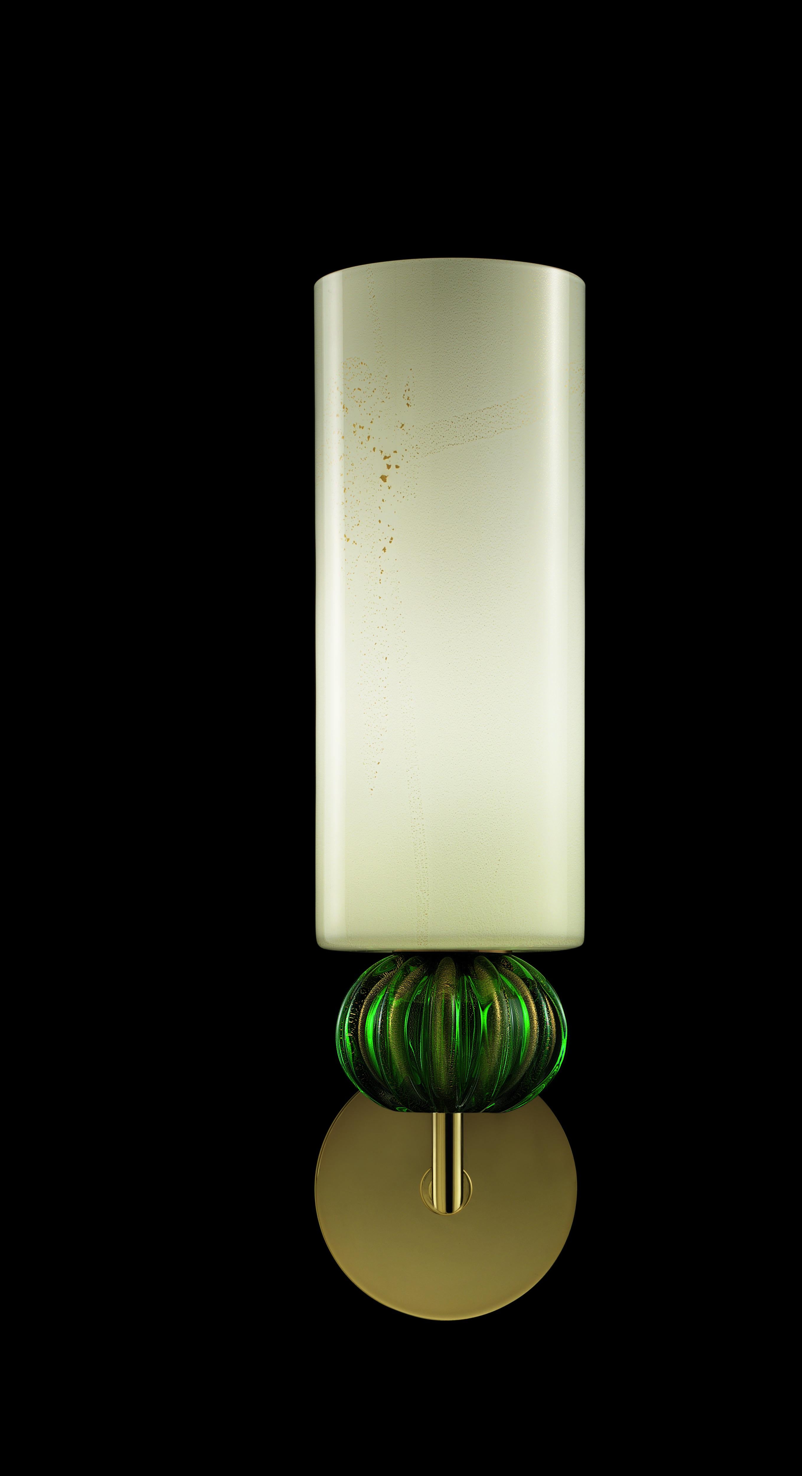 An elegant wall lamp inspired by regular, classical lines and rendered timeless by the warm and welcoming colours: the opaline diffuser is beige, speckled with gold, while the sphere element can be of different colours.
