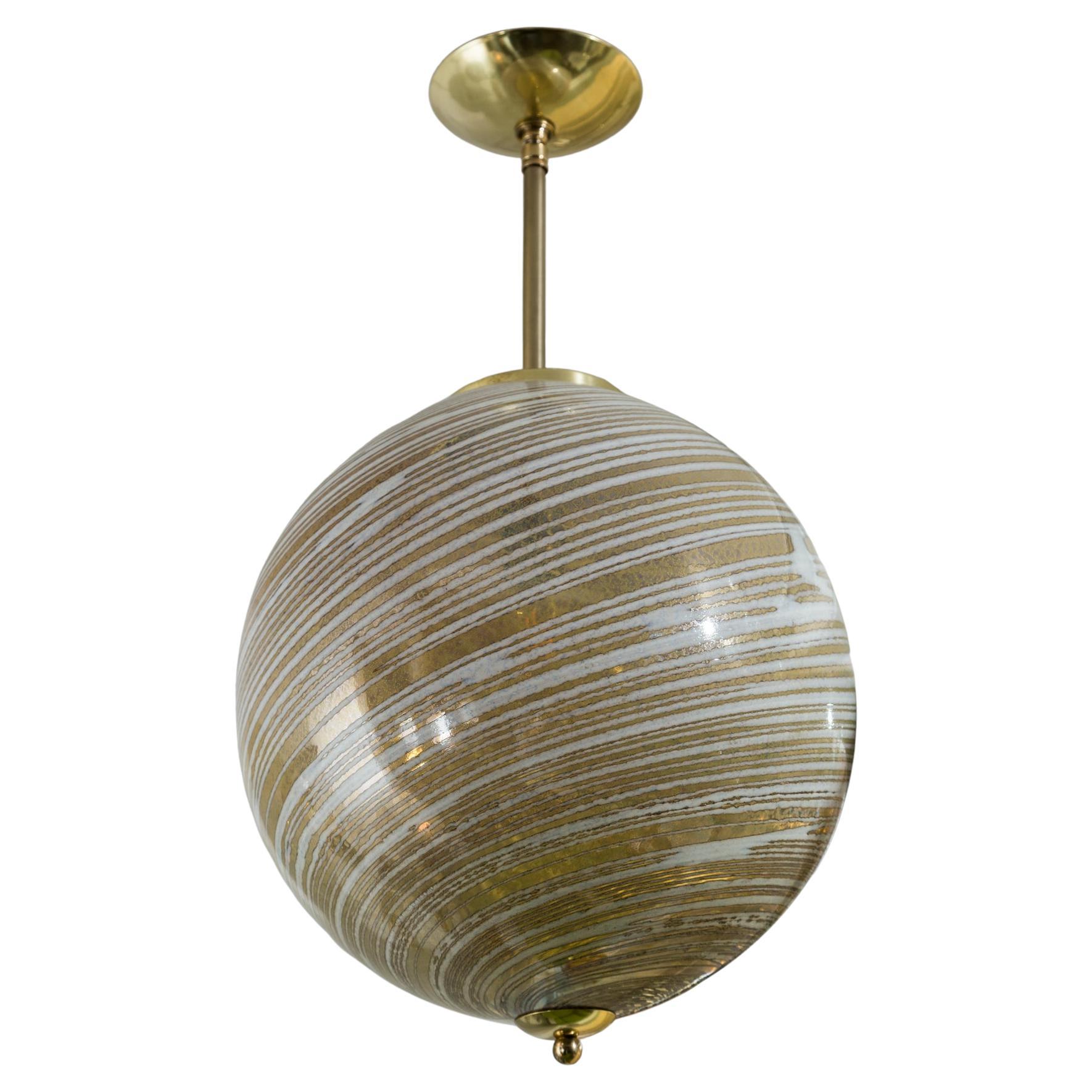 Unique set of commissioned artisan globe shaped pendants blown in a swirl of gold wheat and white colors.  The illumination glows and offers a magical soft illumination.

The frame is fabricated to your desired overall height and finish. The frame