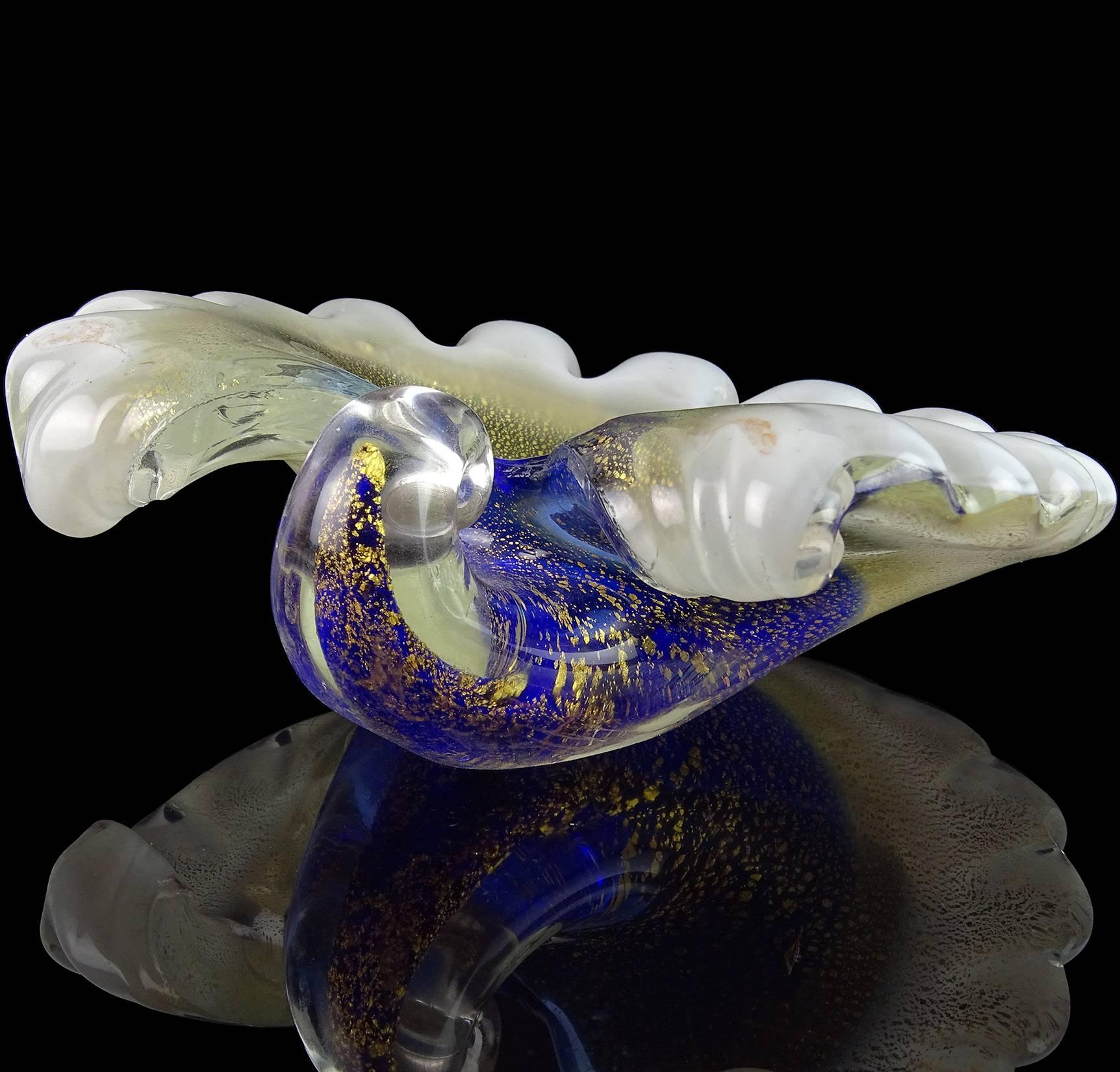 Beautiful vintage Murano hand blown blue, white and gold flecks art glass seashell bowl / sculpture. Created in the manner of the Barovier e Toso Company. It is profusely covered in gold leaf on the outside. Can be used as a display piece on any