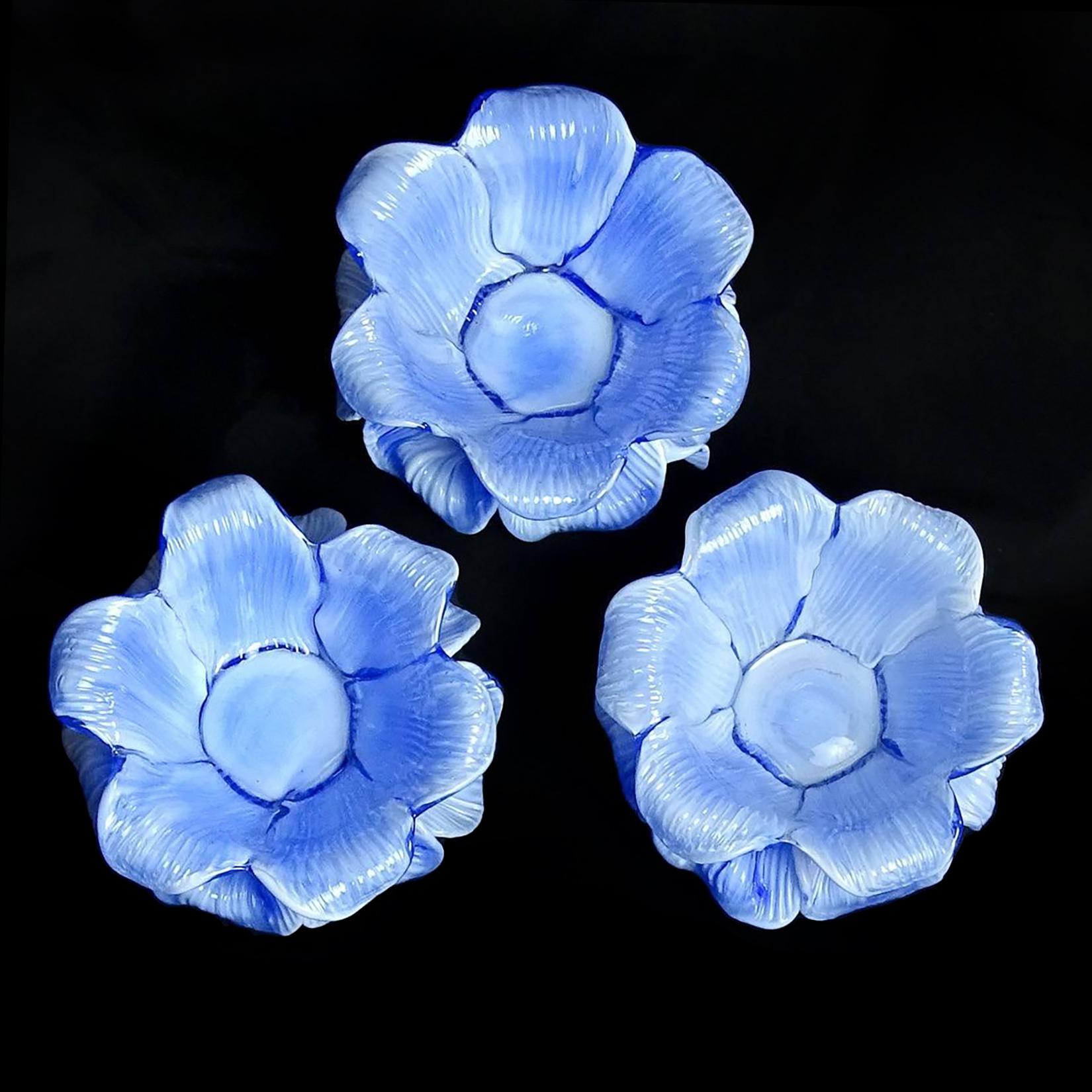 Gorgeous set of 3 Murano hand blown, blue and white double petal Italian art glass flower bowls / candleholders. Attributed to the Fratelli Toso Company, circa 1950s, all with original labels underneath. They have a glass disk on the bottom, and