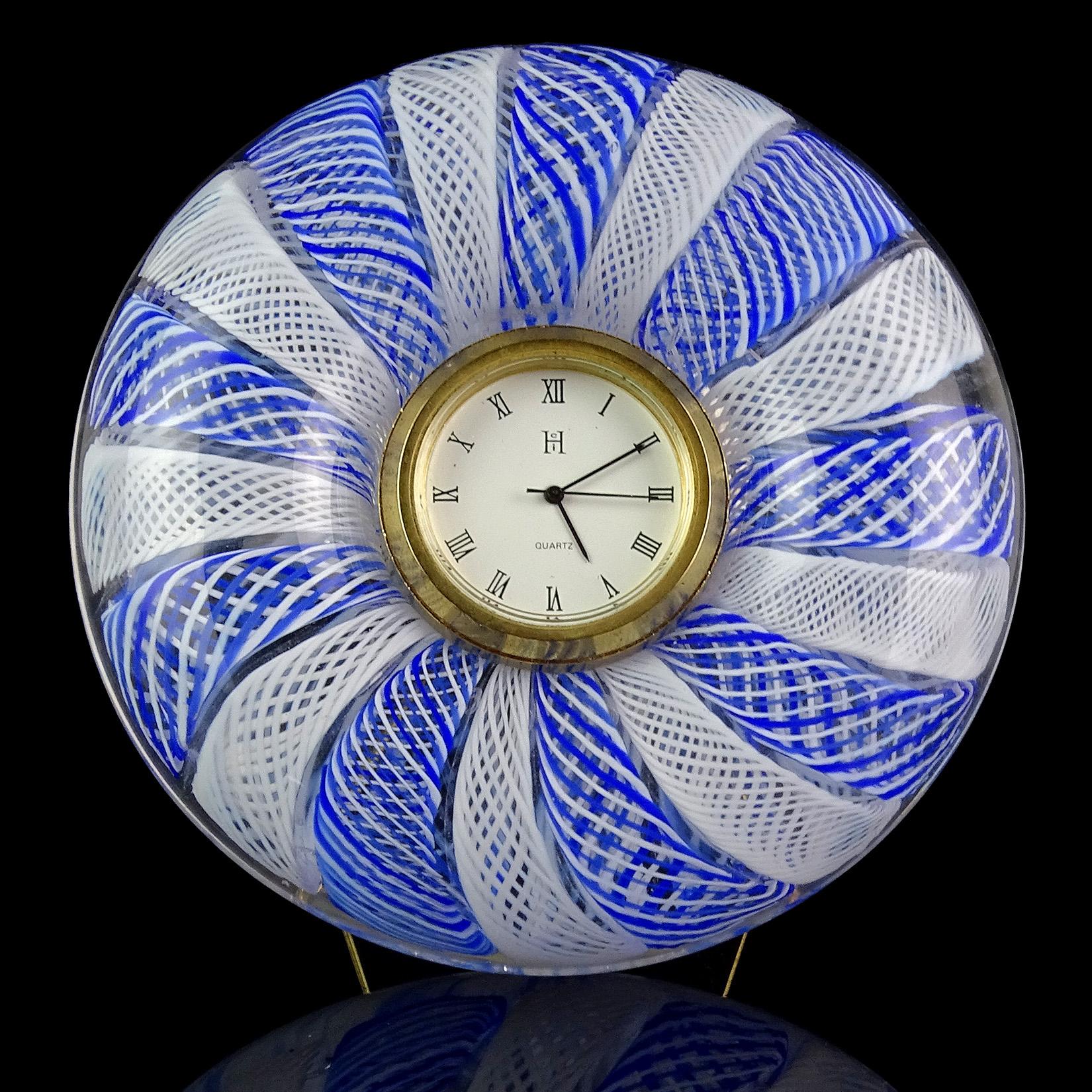 Beautiful Murano hand blown twisted blue and white Zanfirico ribbons Italian art glass desk clock. It has a Quartz clock face, a triangle stand on the back, and battery operated clock face (new battery, currently working). Has original Murano, made