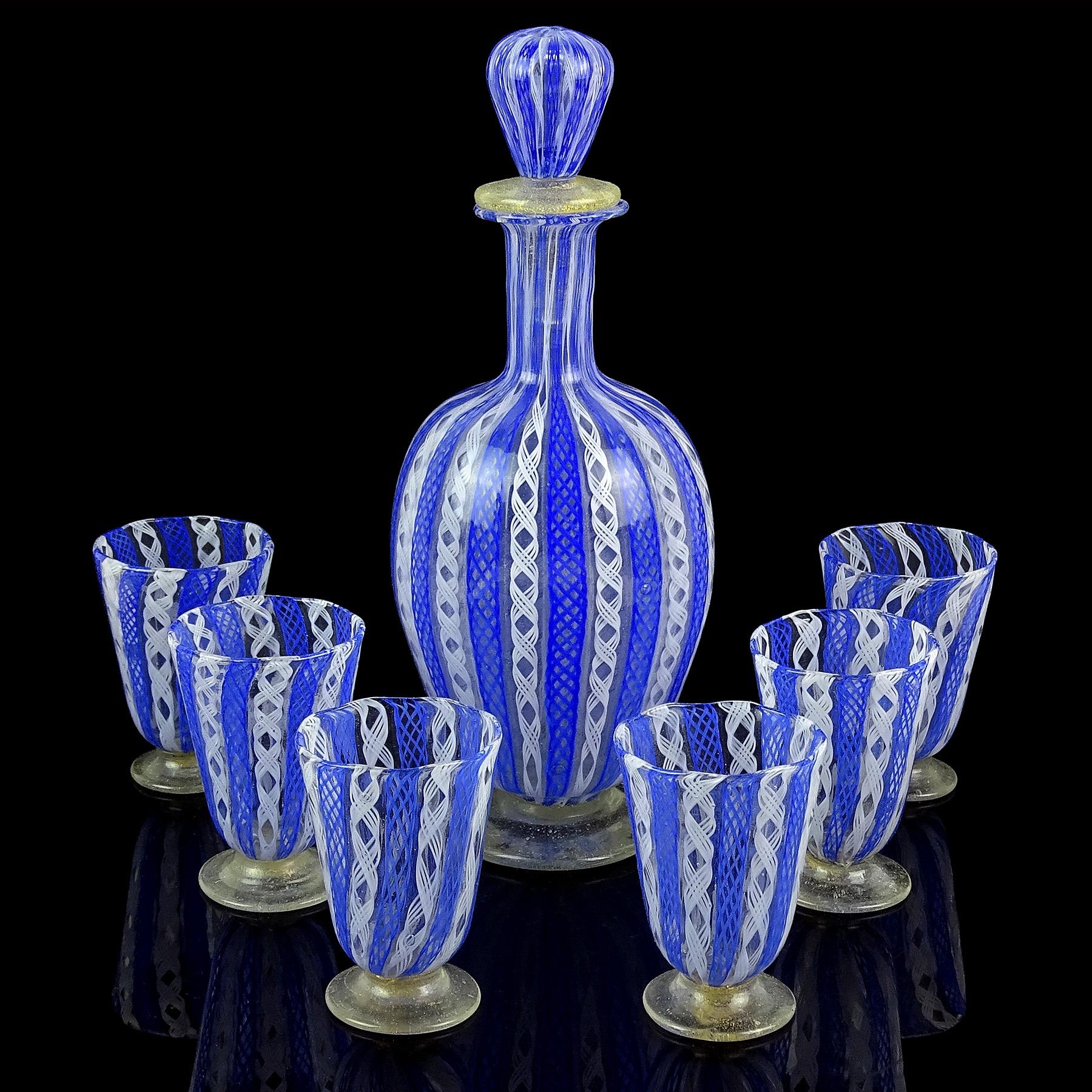 Gorgeous antique Venetian, early Murano hand blown blue and white ribbons Italian art glass seven piece liquor decanter and shot glasses set. Created in the manner of the Salviati and Fratelli Toso companies. The set has Zanfirico blue net and