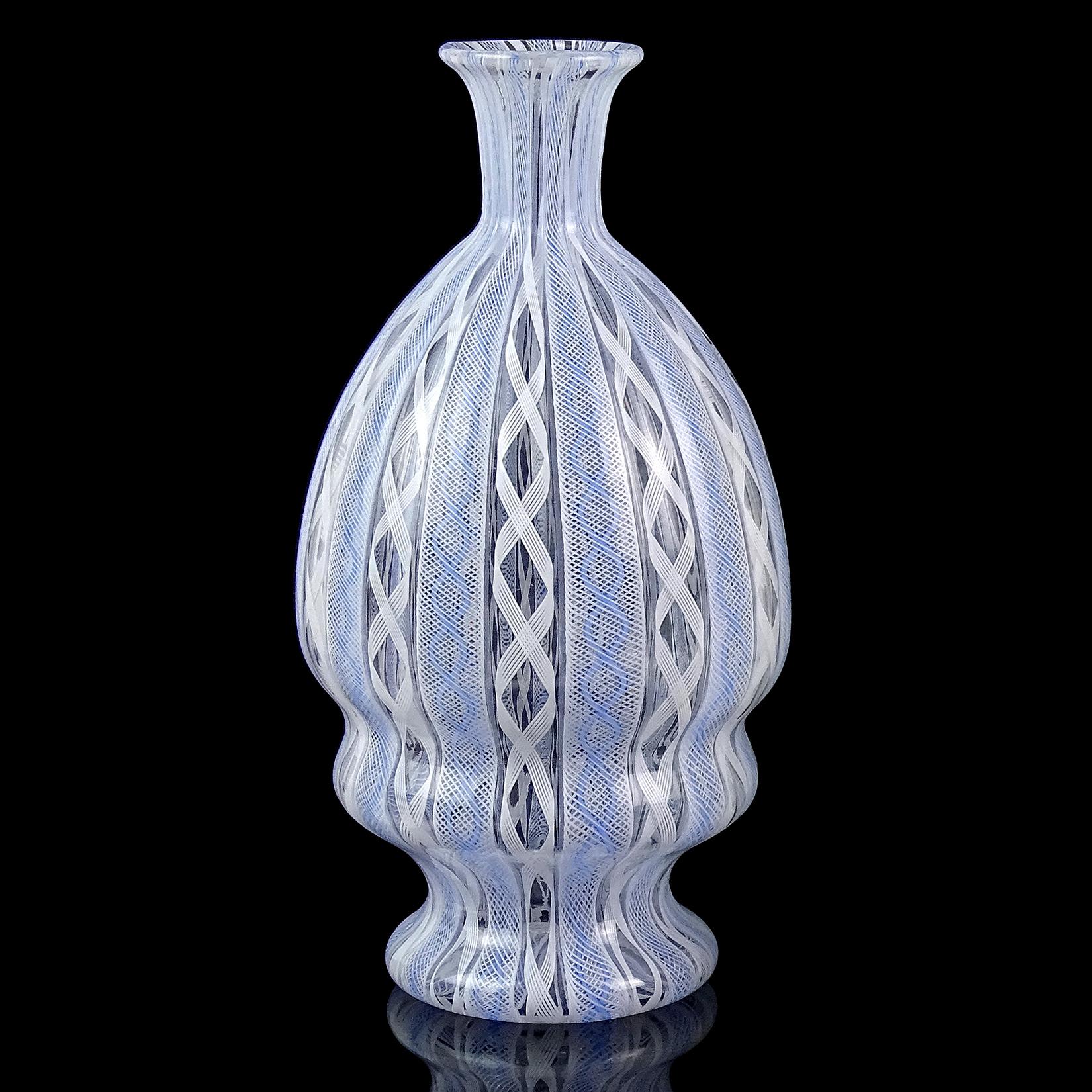 Beautiful vintage Murano hand blown light blue and white ribbons Italian art glass flower vase. Created with alternating, and very intricate Zanfirico twisting ribbons. It has a small flared rim, and sculptural body. Great piece for any desk or