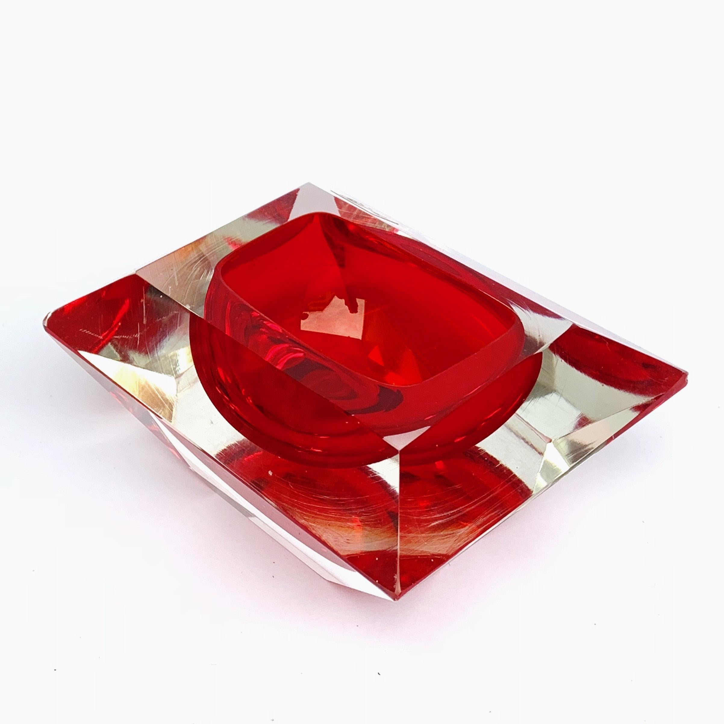This is a Ruby-cut and Ruby-colored sculpture.
Murano ashtray or bowl, attributable to Flavio Poli, Vetro Sommerso. Red faceted glass, Italy, 1950s.

No chipping.
