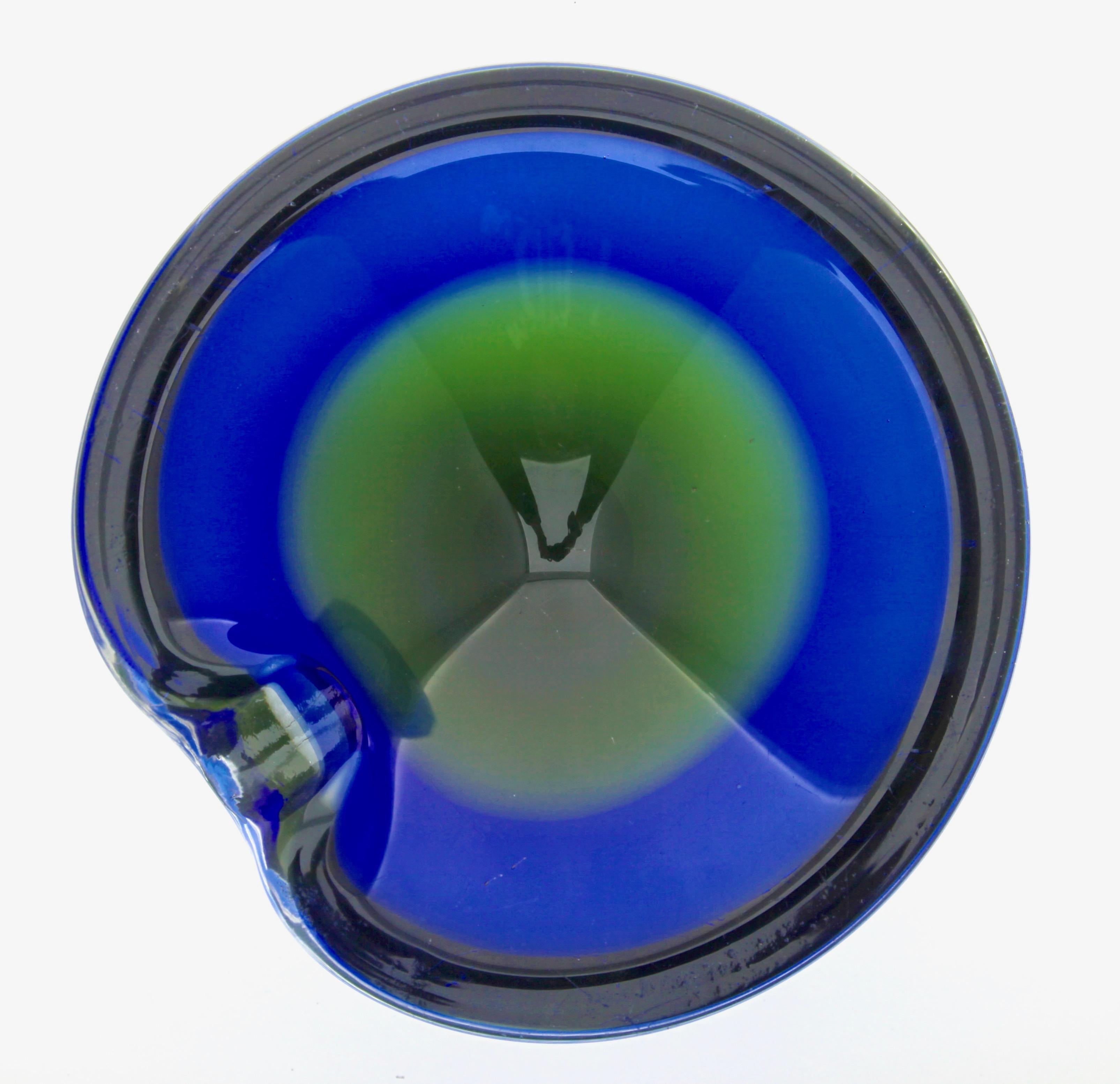 The bowl has sommerso colour within the glass of blue and Green. 
The blue rim sits on the Green coloured sommerso glass.
Fantastic freeform sculptural art glass geode bowl probably designed by Gino Cenedese.