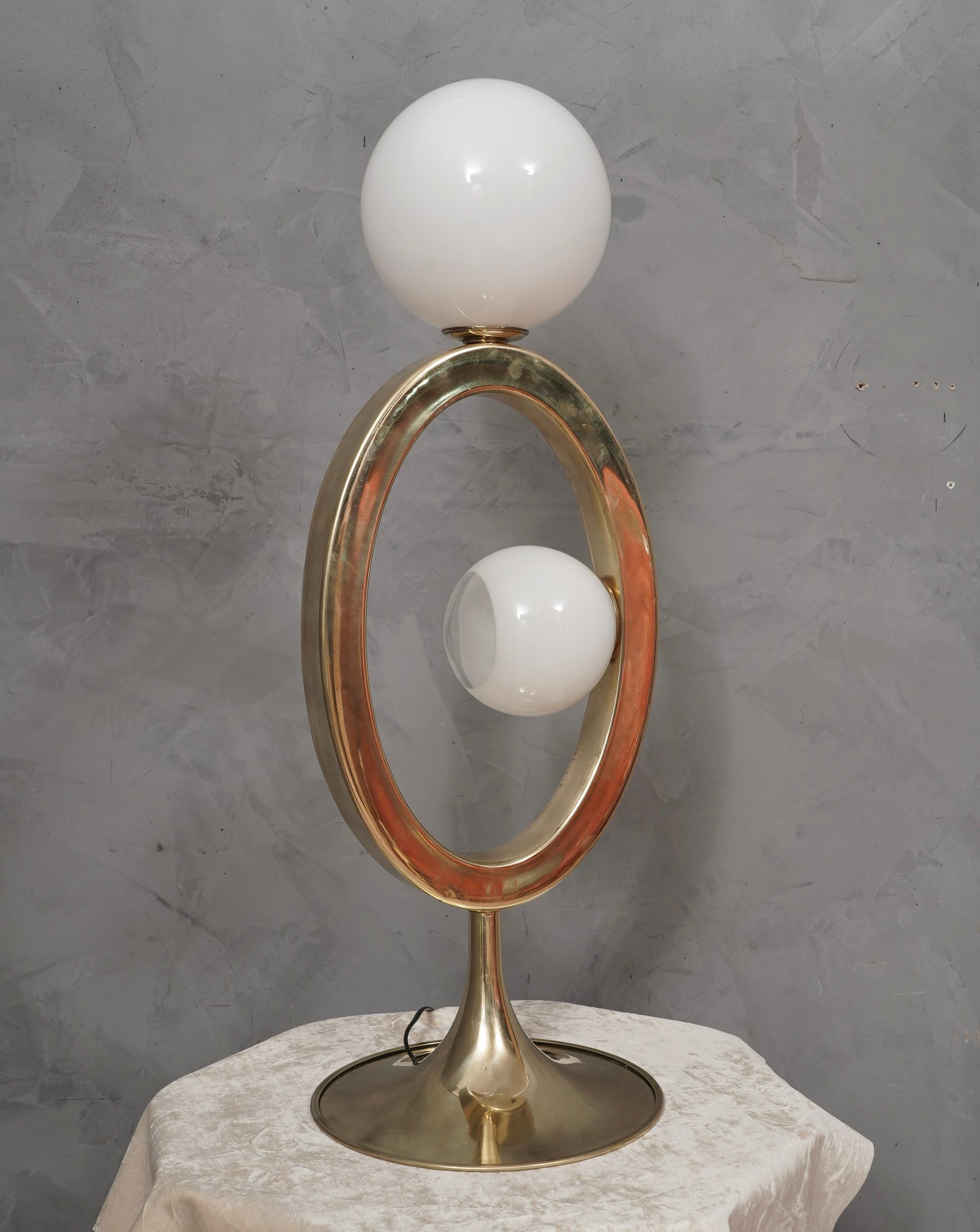 Original and characteristic table lamps in brass and Murano glass. One of a kind design, designed and made especially for our HannauRoma Store.

The lamp is formed by a very modern oval brass structure, to which a white Murano glass sphere has been