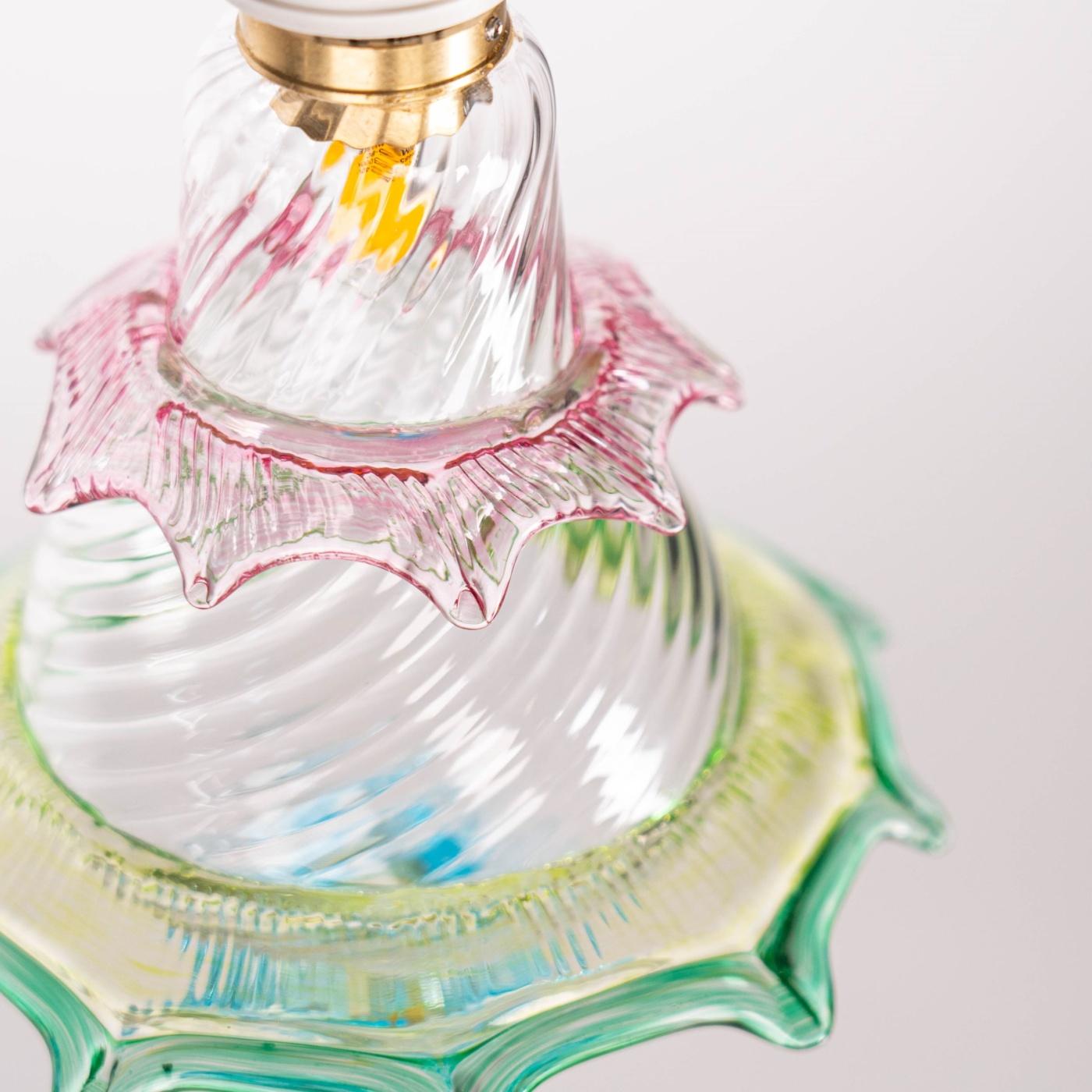 Blown glass body worked in balloton is decorated with evocative and original colors and shapes from the Murano craft tradition. The central body is surrounded by a rostral decoration in light blue glass, a ruby-colored morrisa with pulled pincers