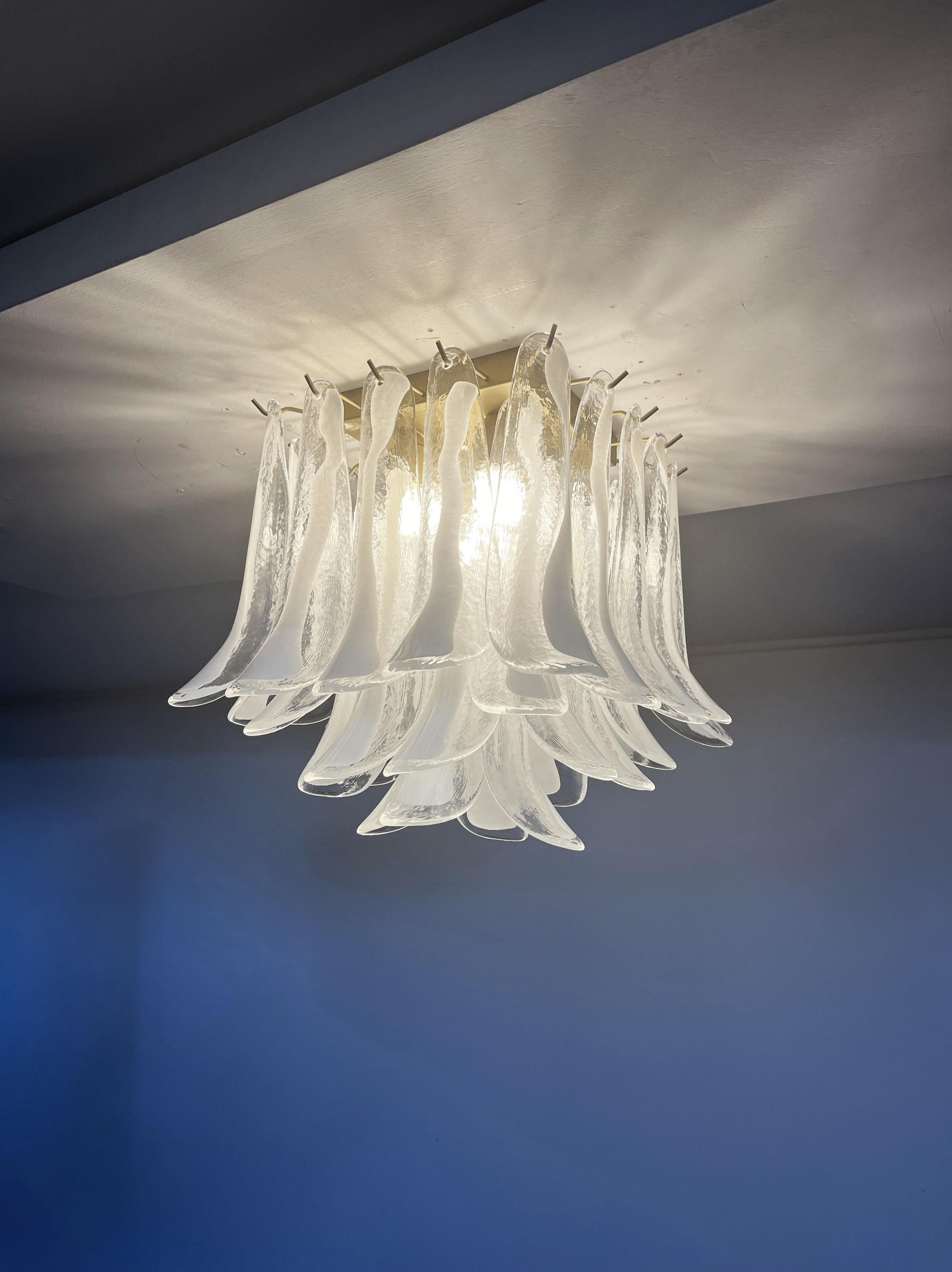 Spectacular ceiling lamp with 32 Murano lattimo glass petals (clear with white lattimo spot) in golden painted metal frame.  Elegant lighting object.
Period: late XX century
Dimensions: 19,20 inchs (50 cm) height; 19,20 inches (50 cm) width; 19,20