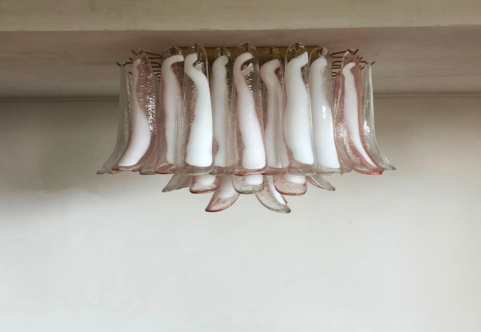 Spectacular ceiling lamp with 64 Murano glasses. The glasses have two different colors, half are transparent with white spots and half are pink with white spots. Elegant lighting object.
Period: Late 20th century
Dimensions: 15.75 inches (40 cm)
