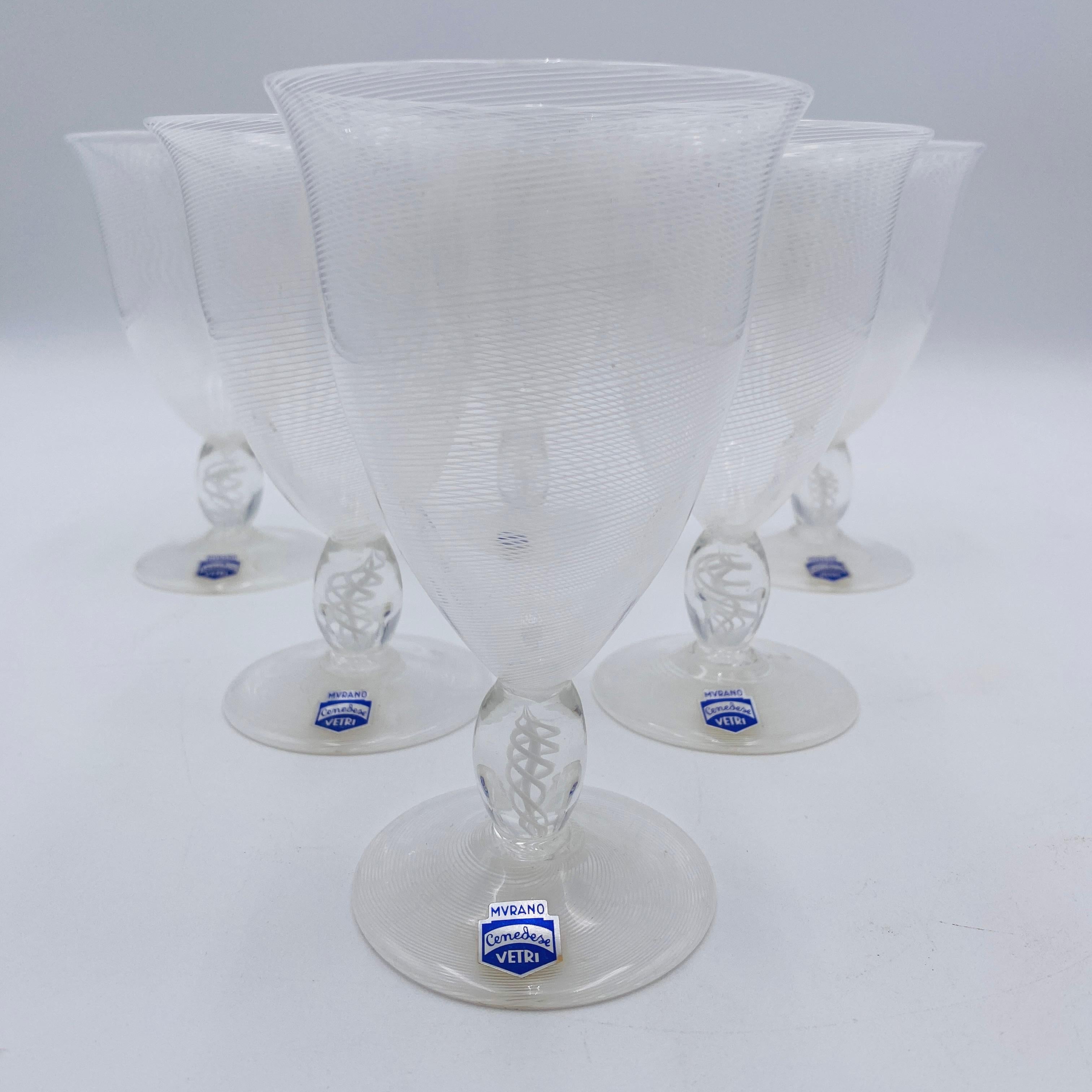 This image shows a set of Murano Cenedese Vetri wine glasses made in Italy. These are likely made from lead-free crystal, known for clarity and resonance. The distinctive white, swirled pattern suggests a 