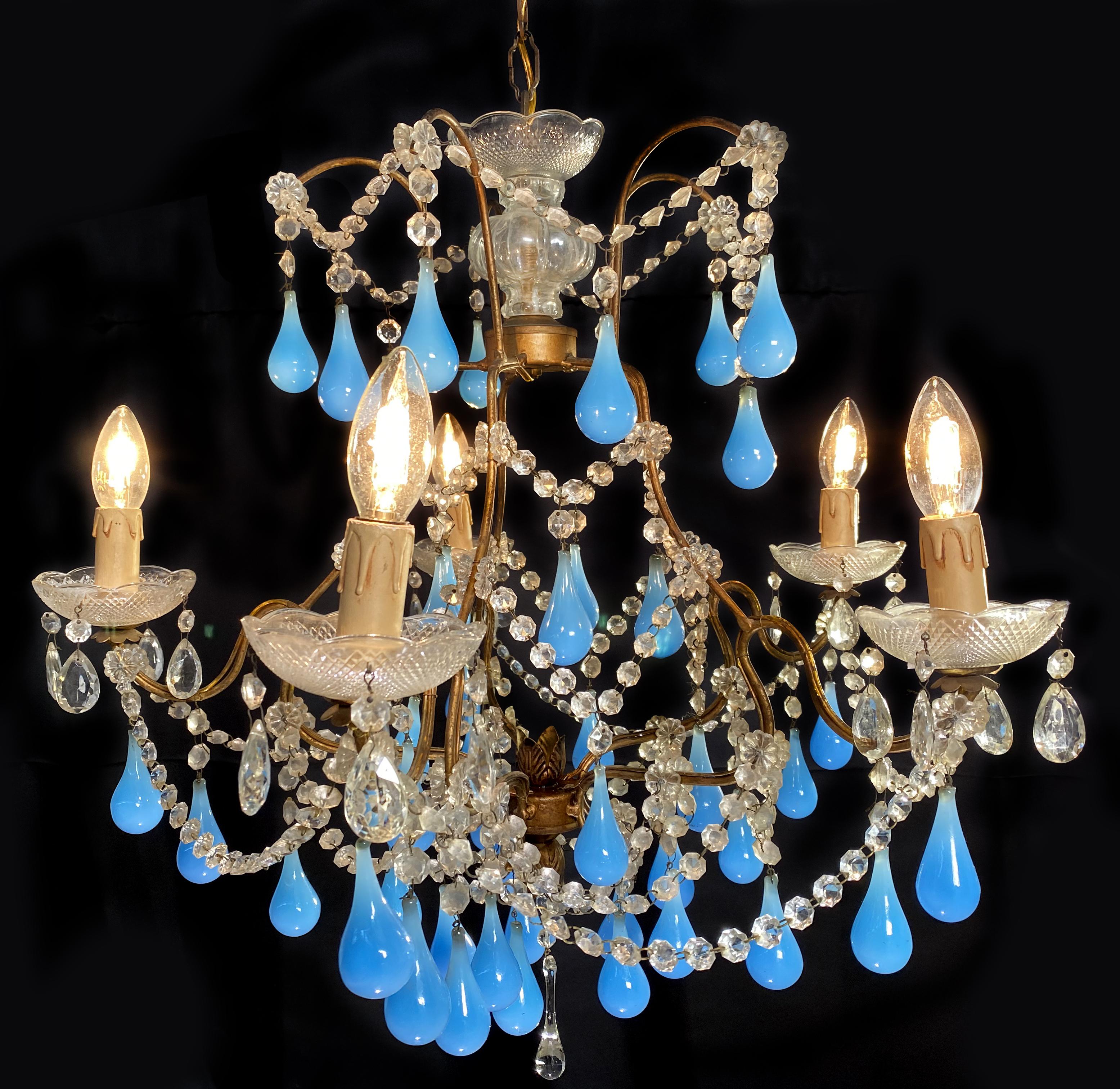 Elegant Murano chandelier. Dozens of blue drops hang from the golden canopy.
 