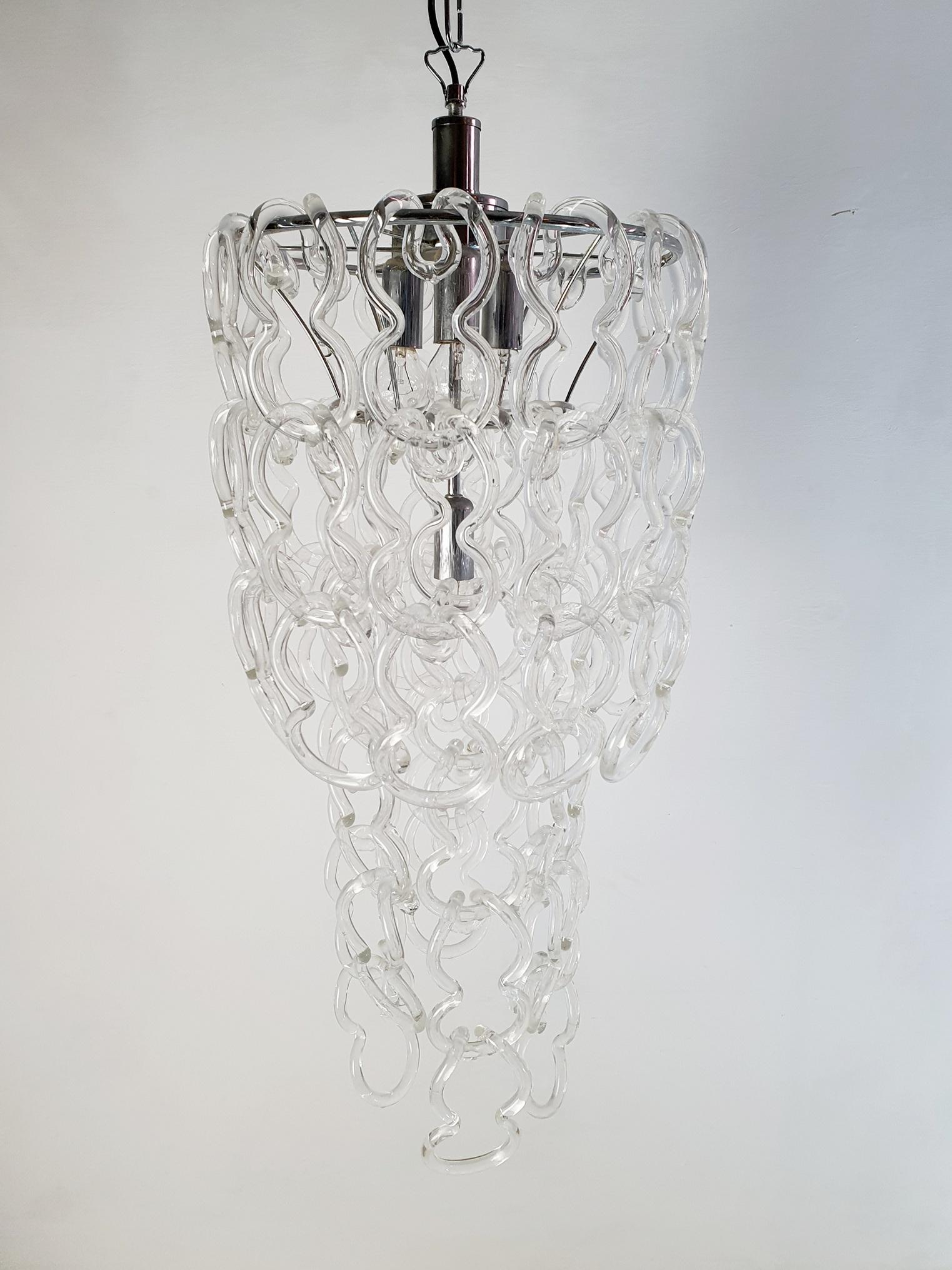 An original Giogali chandelier by Angelo Mangiarotti for Vistosi with Murano glass hanging from a chrome structure. The glass pieces can be hung a bit differently creating different heights for the chandelier. The height in this manner of the actual