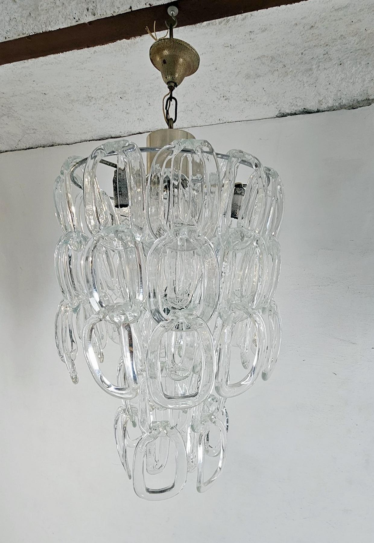 An original Giogali chandelier by Angelo Mangiarotti for Vistosi with Murano glass hanging from a chrome structure. The glass pieces can be hung a bit differently creating different heights for the chandelier. The height in this manner of the actual