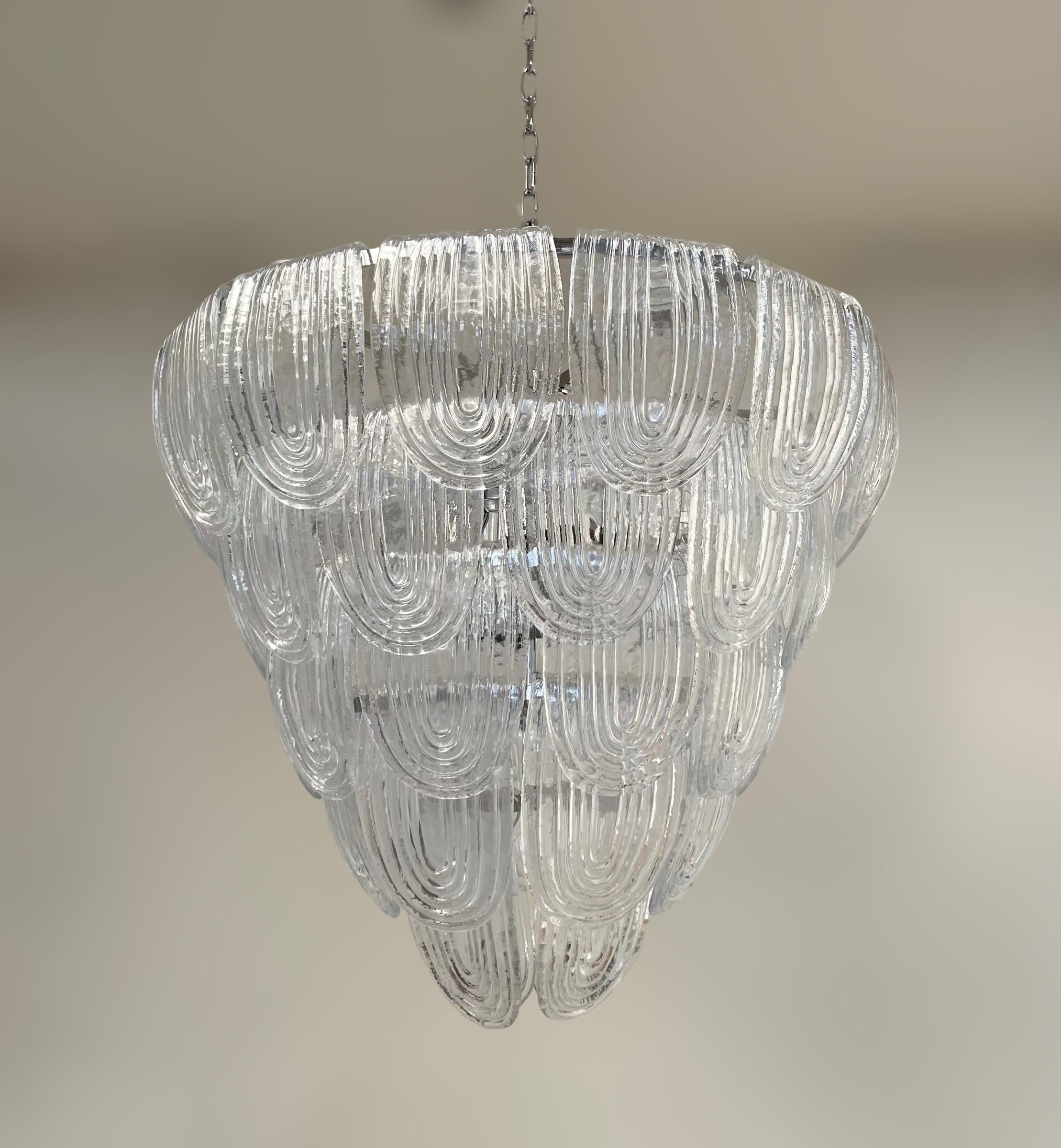Italian chandelier with vintage 1960s clear ribbed curved Murano glasses, mounted on newly made chrome finish metal frame / Made in Italy
12 ights / E26 or E27 type / max 60W each
Measures: diameter 31.5 inches, height 28 inches, total height 56