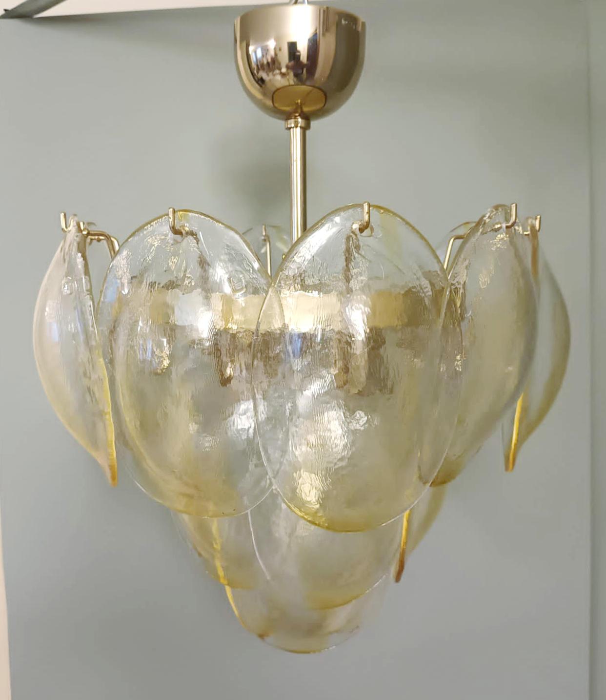 Vintage Italian chandelier with clear and amber glass shells suspended on brass frame / Made in Italy by La Murrina, circa 1980s
Original mark on glasses and ceiling canopy
Measures: diameter 16 inches, height 20 inches including rod and canopy
3