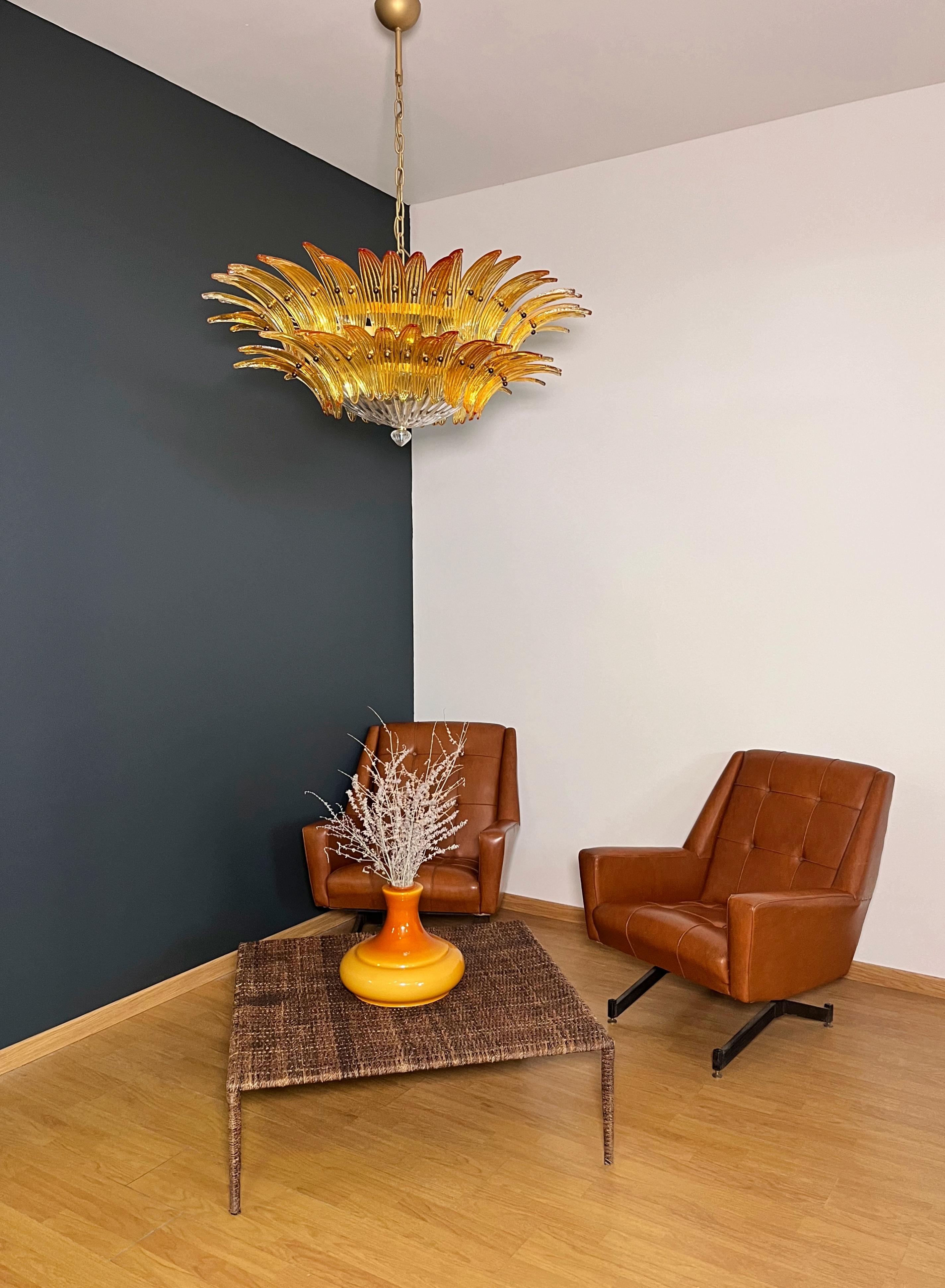 Luxury and GENUINE Murano Glass chandelier. HAND MADE IN MURANO. It made by 82 Murano amber  glasses, two levels,  in a gold painted metal frame.  The chandelier also has a Murano clear glass base at the end of the lamp. Murano blown glass in a