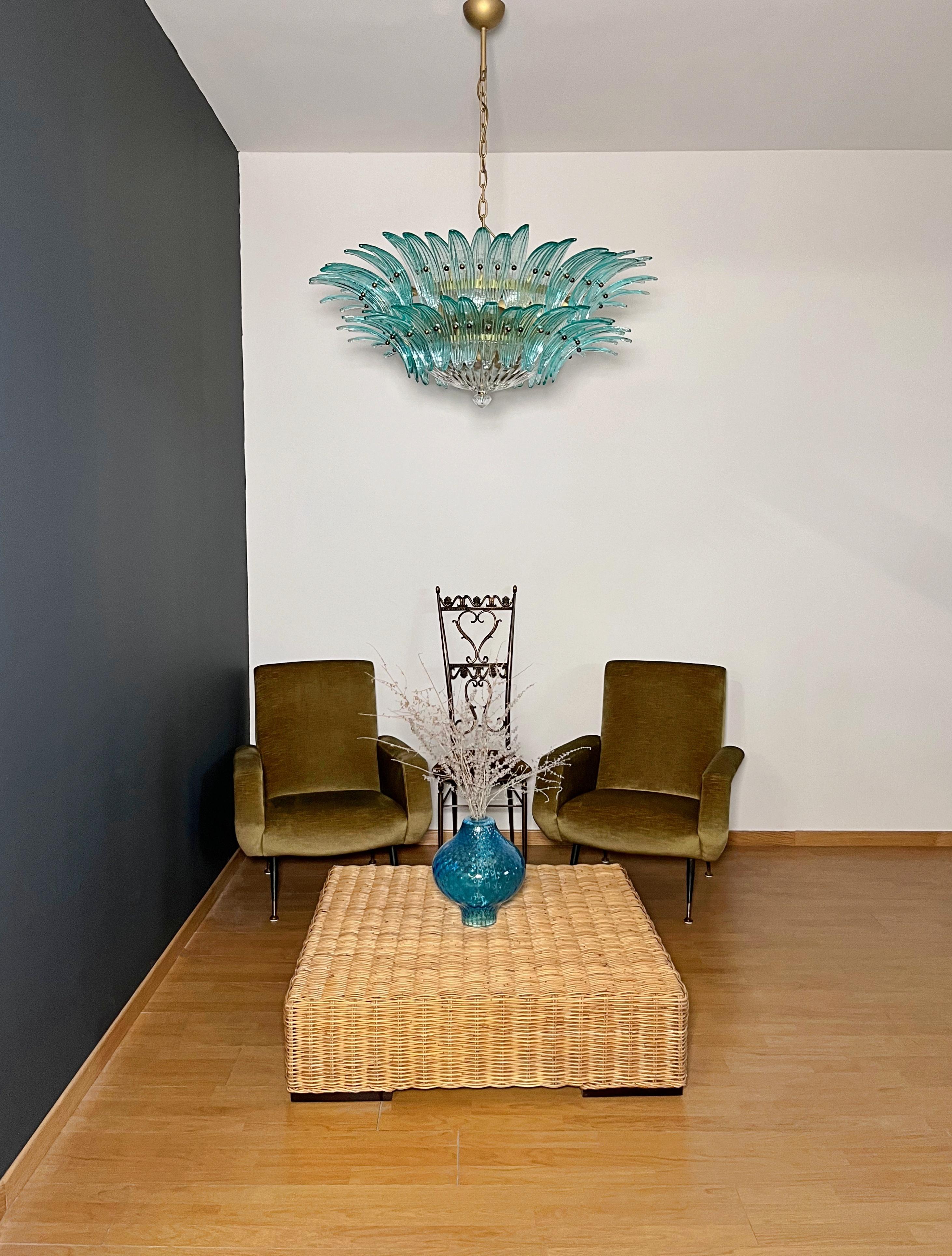 Luxury and GENUINE Murano Glass chandelier. HAND MADE IN MURANO. It made by 82 Murano turquoise  glasses, two levels,  in a gold painted metal frame.  The chandelier also has a Murano clear glass base at the end of the lamp. Murano blown glass in a