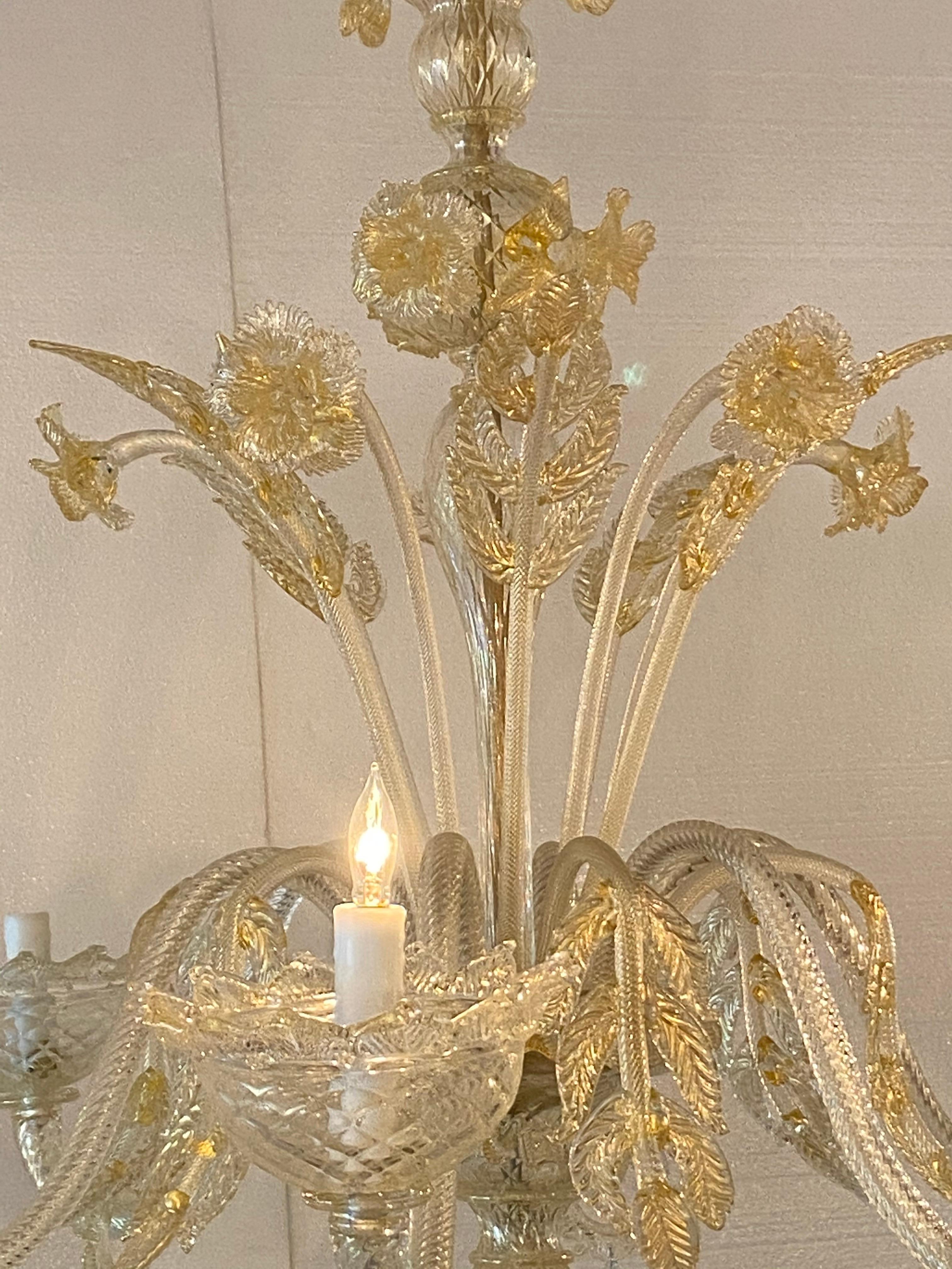 Beautiful gold and clear Murano chandelier, electrified chandelier with six arms and, six bone wax candle covers with drips.