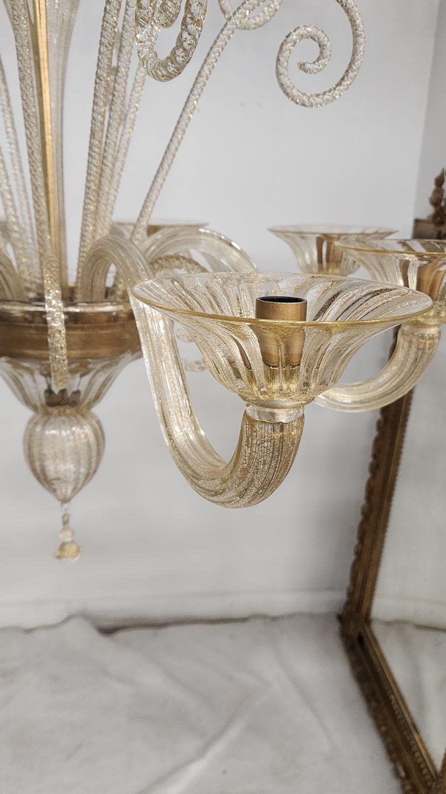 Venetian Murano Chandelier. With gold specks inside the glass. It has 8 lights and is ready to hang with new wiring. 