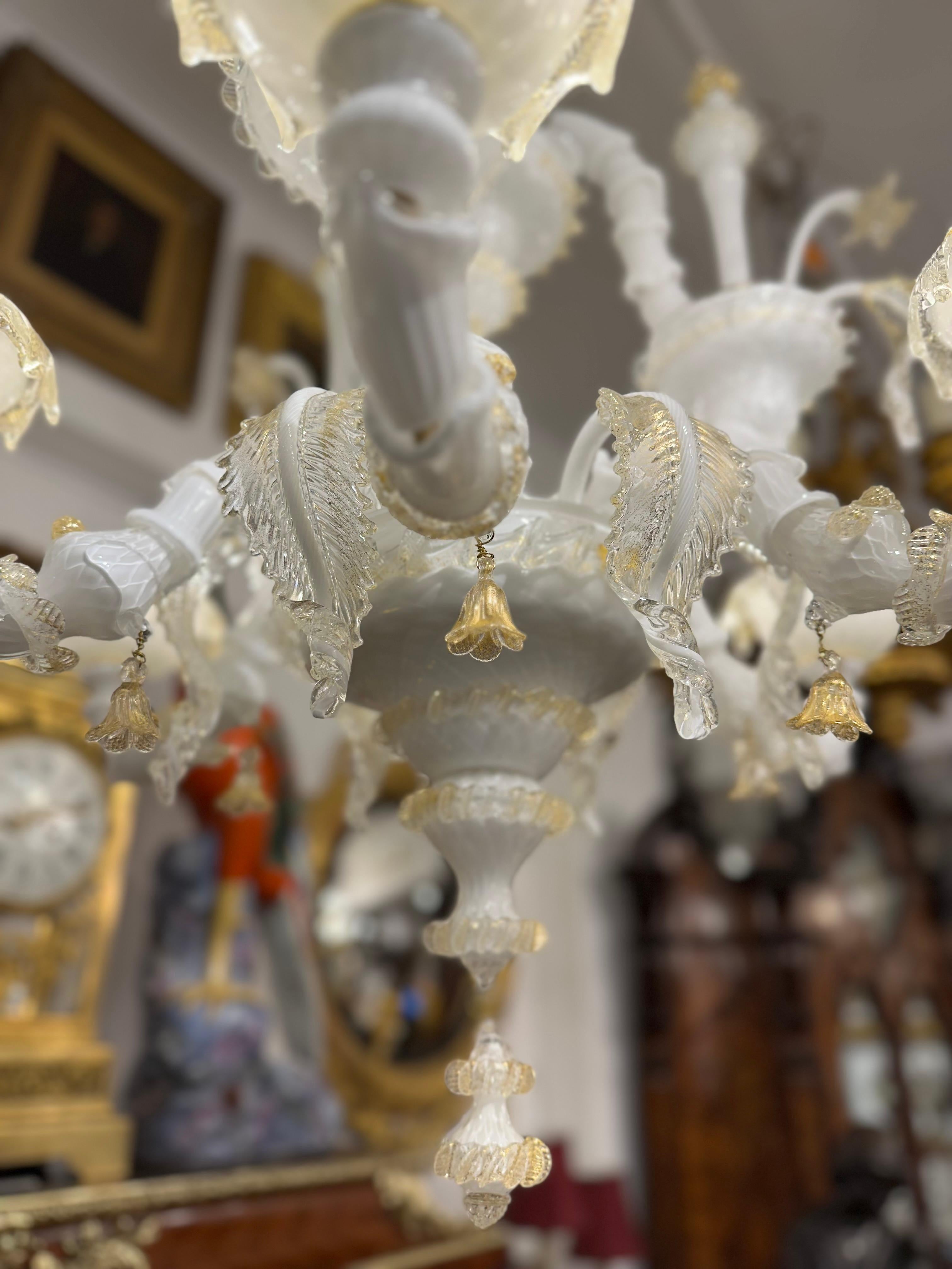 A stunning murano chandelier in white and gold, skilfully handblown in Italy. Murano glass is world renown, with a long history spanning centuries. Popular with aristocrats, celebrities and interior designers throughout the world they have a unique