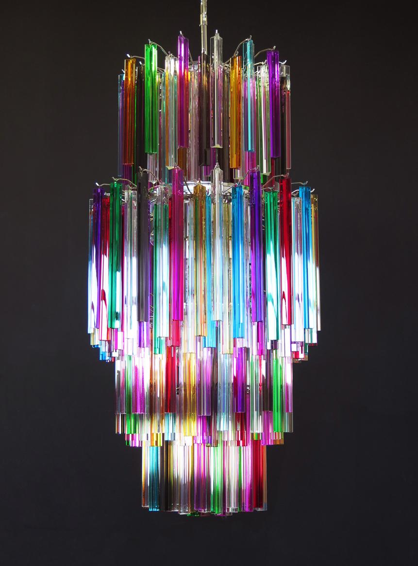 Fantastic vintage Murano chandelier made by 242 Murano crystal multicolored prism (TRIEDRI) on four levels in a nickel metal frame. The glasses are transparent, blue, smoky, purple, green, yellow and pink. The glasses have two different