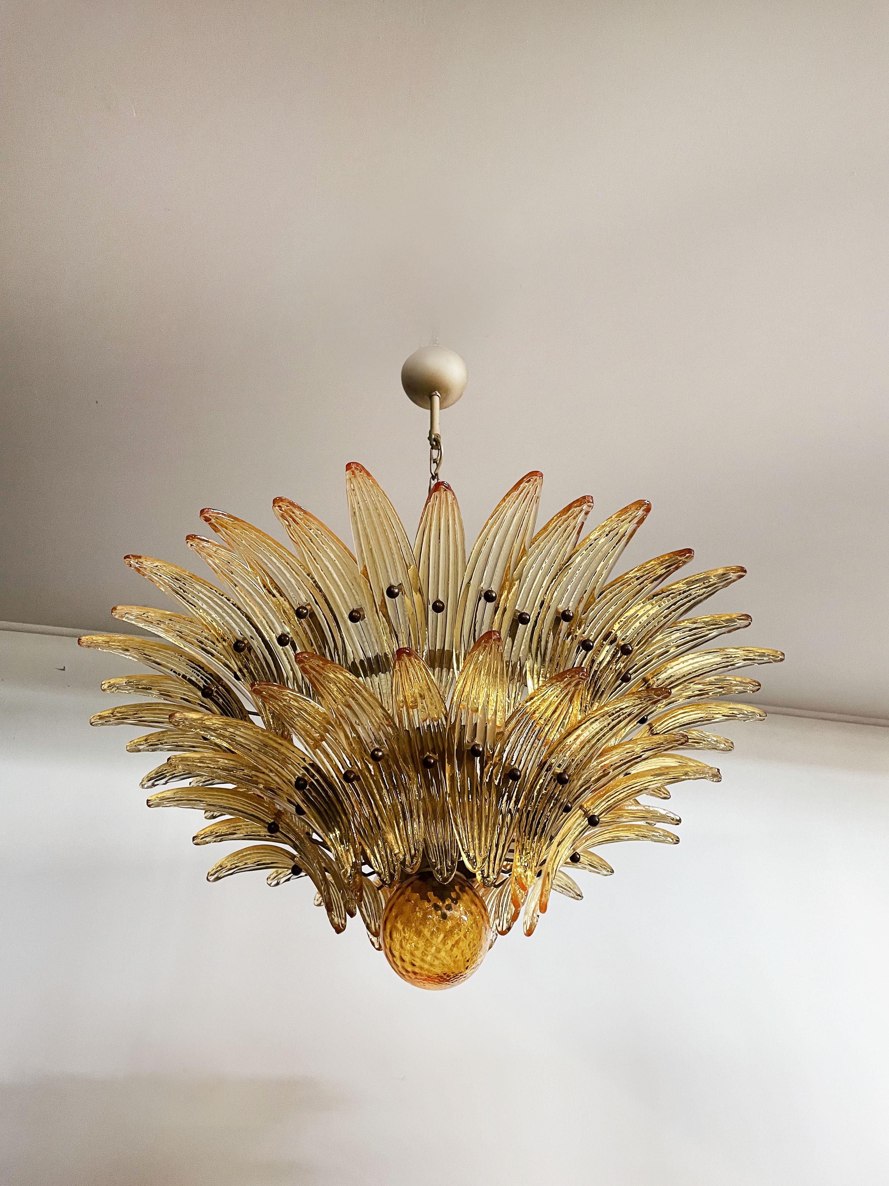 Luxury and GENUINE Murano Glass chandelier. HAND MADE IN MURANO. It made by 58 Murano amber glasses in a gold metal frame.  The chandelier has also a Murano glass ball in the end of the lamp. Murano blown glass in a traditional way.
Period: late XX