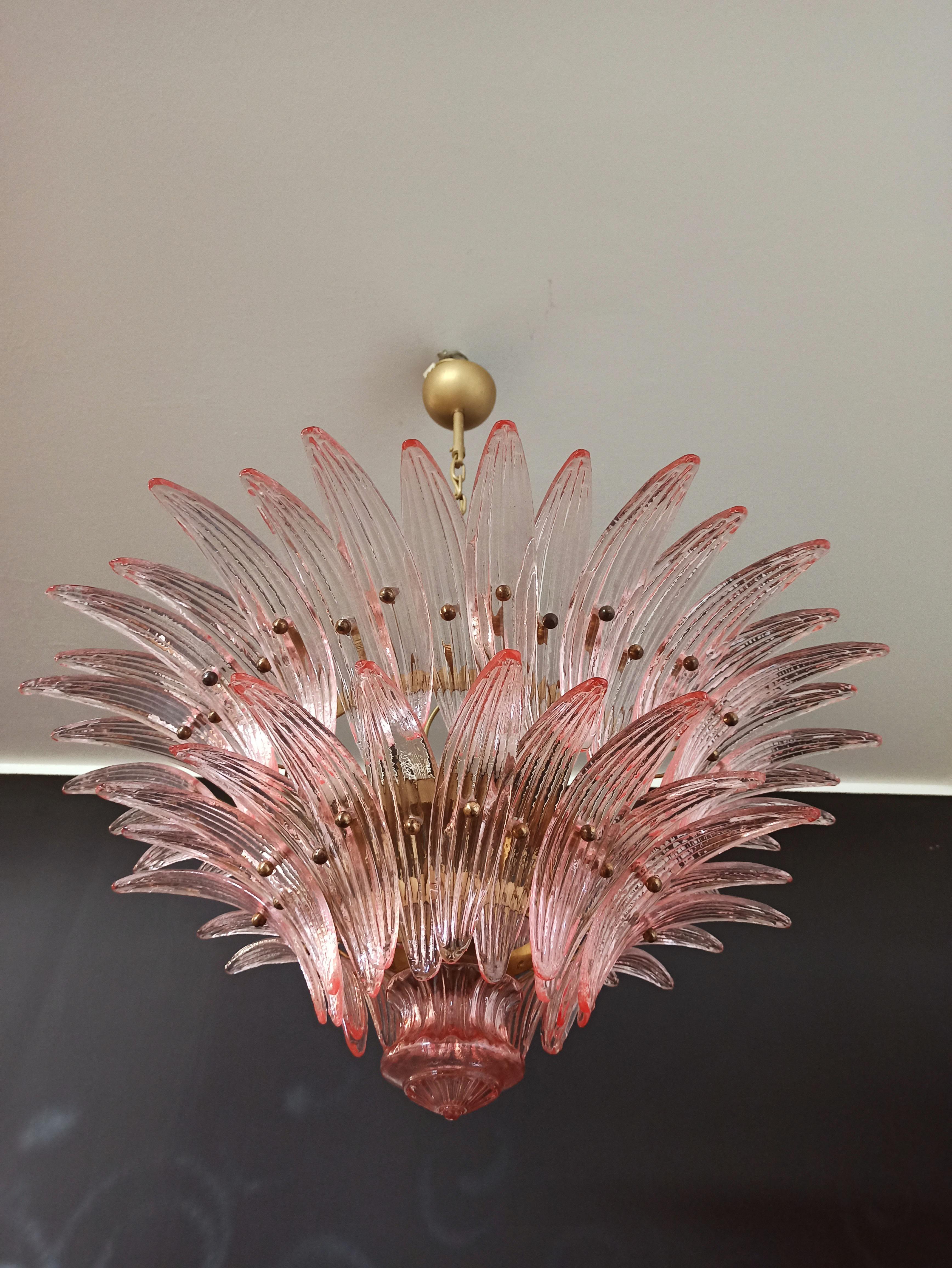 Luxury and genuine Murano glass chandelier. Hand made in MURANO. It made by 58 Murano pink glasses in a gold metal frame. The chandelier has also a Murano glass ball in the end of the lamp. Murano blown glass in a traditional way.
Period: 1970's /