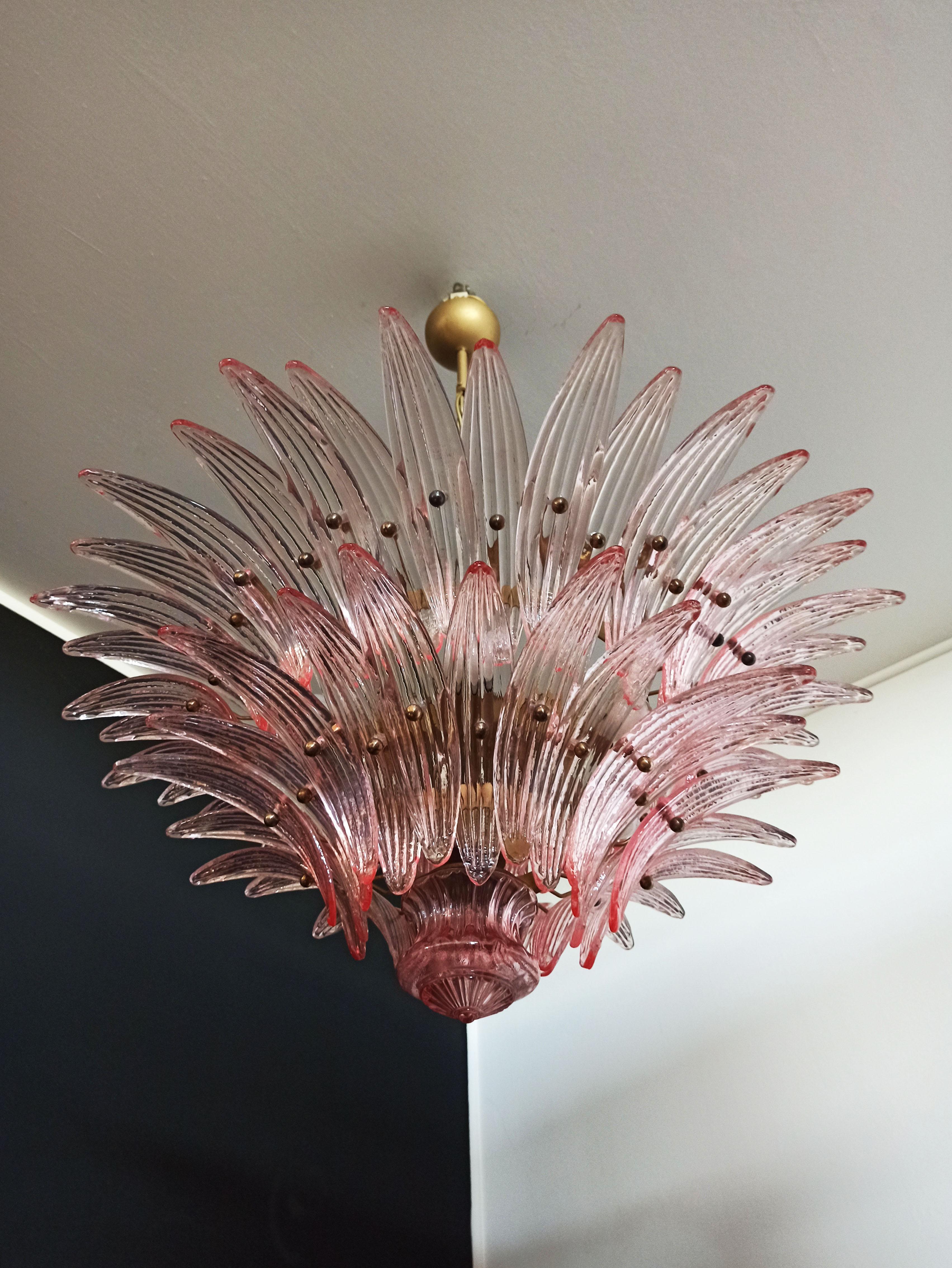 Luxury and genuine Murano glass chandelier. Hand made in Murano. It made by 58 Murano pink glasses in a gold metal frame. The chandelier has also a Murano glass ball in the end of the lamp. Murano blown glass in a traditional way.
Period: 1970's /