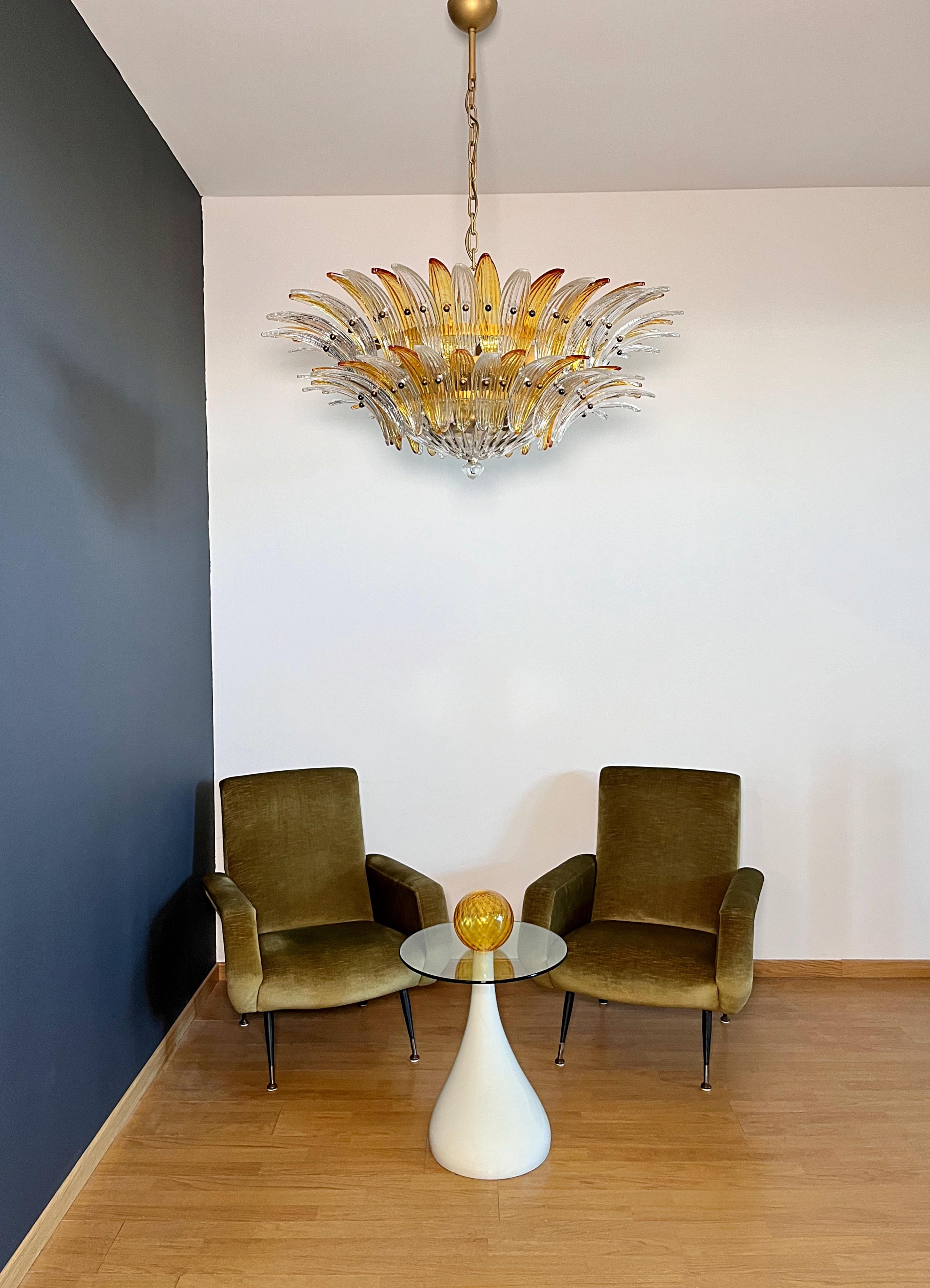 Luxury and GENUINE Murano Glass chandelier. HAND MADE IN MURANO. It made by 82 Murano amber and clear  glasses, two levels,  in a gold painted metal frame.  The chandelier has also a Murano clear glass base in the end of the lamp. Murano blown glass