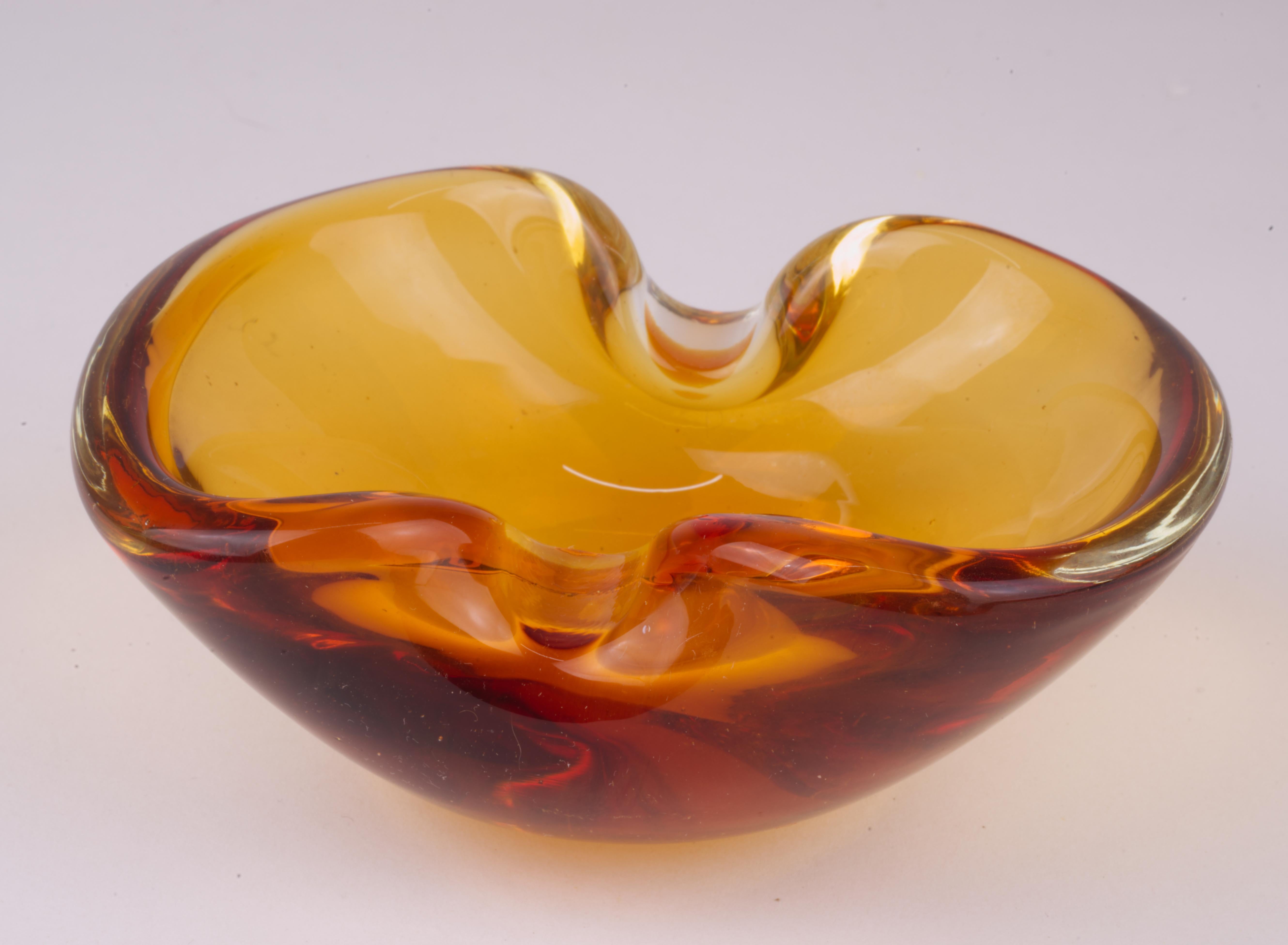  Geode bowl or dish was hand blown in sommerso technique with amber colored glass encased in layer of clear glass in Murano, Italy. 

The bowl is not signed; similar bowls in this style were made by several artists, including Archimede Seguso and