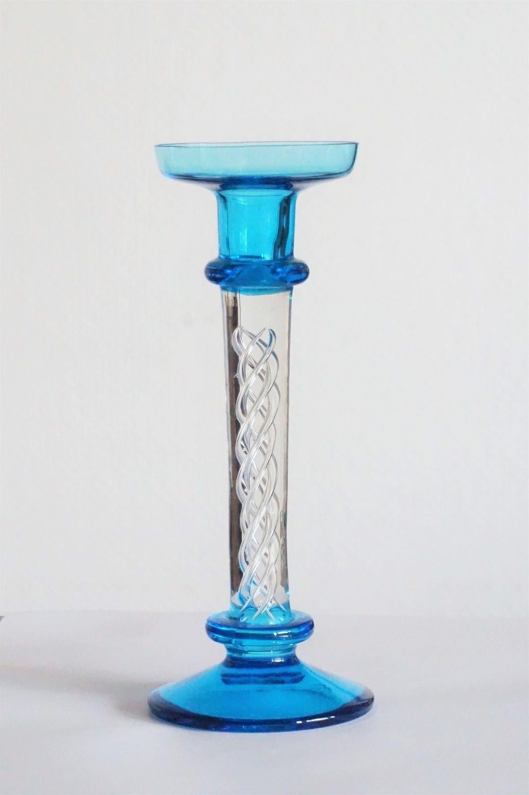 Murano clear and turquoise glass candlestick with beautiful glass artwork inside, 1960s, without damage.
Measures: Height 9.45 in (24 cm)
Diameter/base 3.94 in (10 cm)
Diameter/top 3.35 in (8.50 cm.

Very good condition, no chips or cracks.