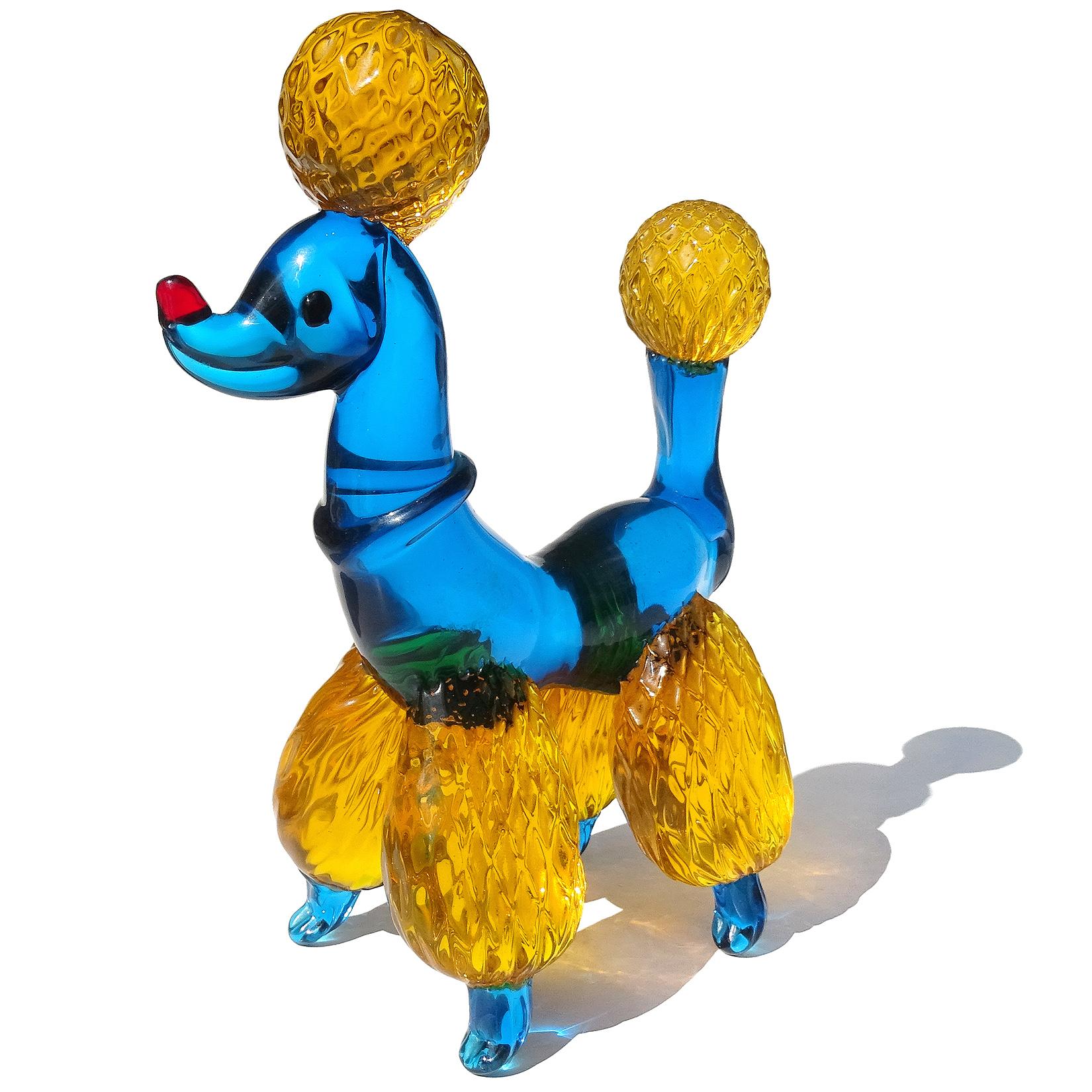 Beautiful vintage Murano hand blown cobalt blue and orange Italian art glass poodle puppy dog sculpture. It has a diamond quilted pom-pom design on the legs, tail and puff on its head. There is a blue collar around the neck, red nose, and applied