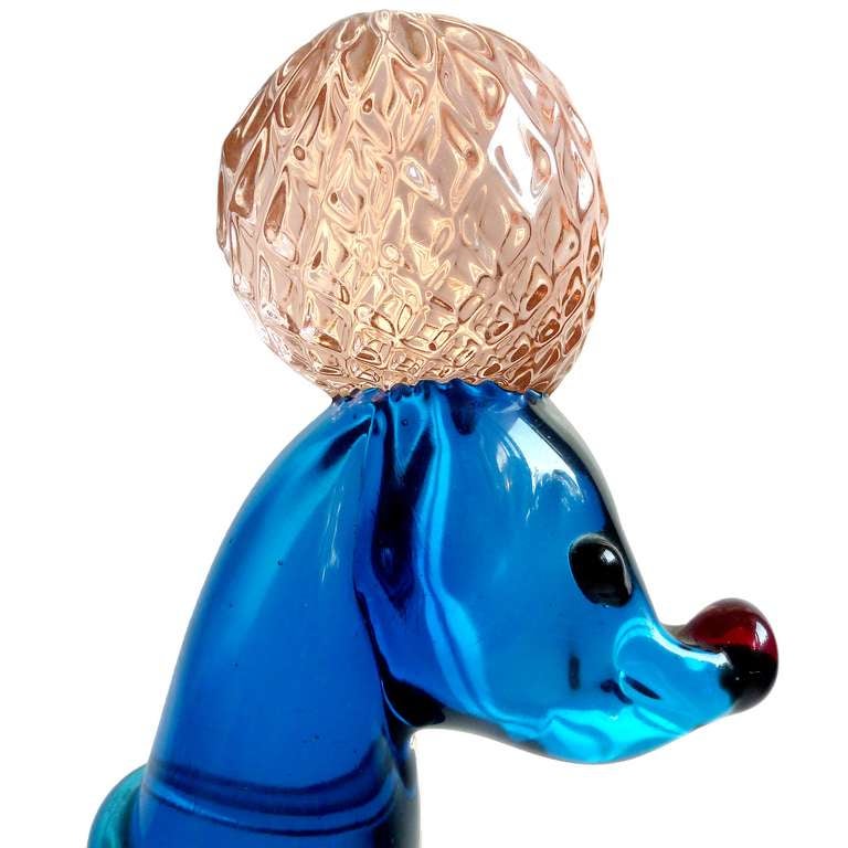 Beautiful vintage Murano hand blown cobalt blue and pink Italian art glass poodle puppy dog sculpture. It has a quilted pom-pom design on the legs, tails and puff on its head. Blue collar around the neck, and red nose and eyes. Very well groomed