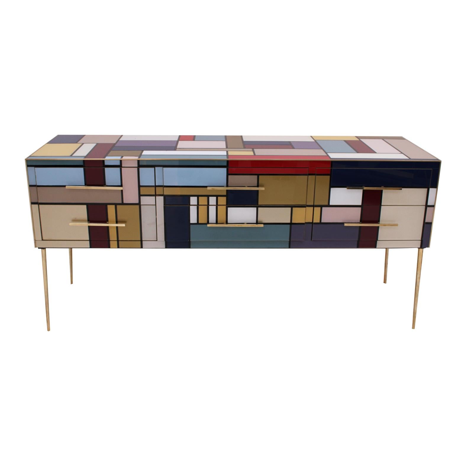 Italian sideboard with six drawers and four legs, with wooden structure covered in colored Murano glass, profiles, handles and feet in brass. Italian manufacture.

Production can last between 5 and 6 weeks.

Every item LA Studio offers is checked by