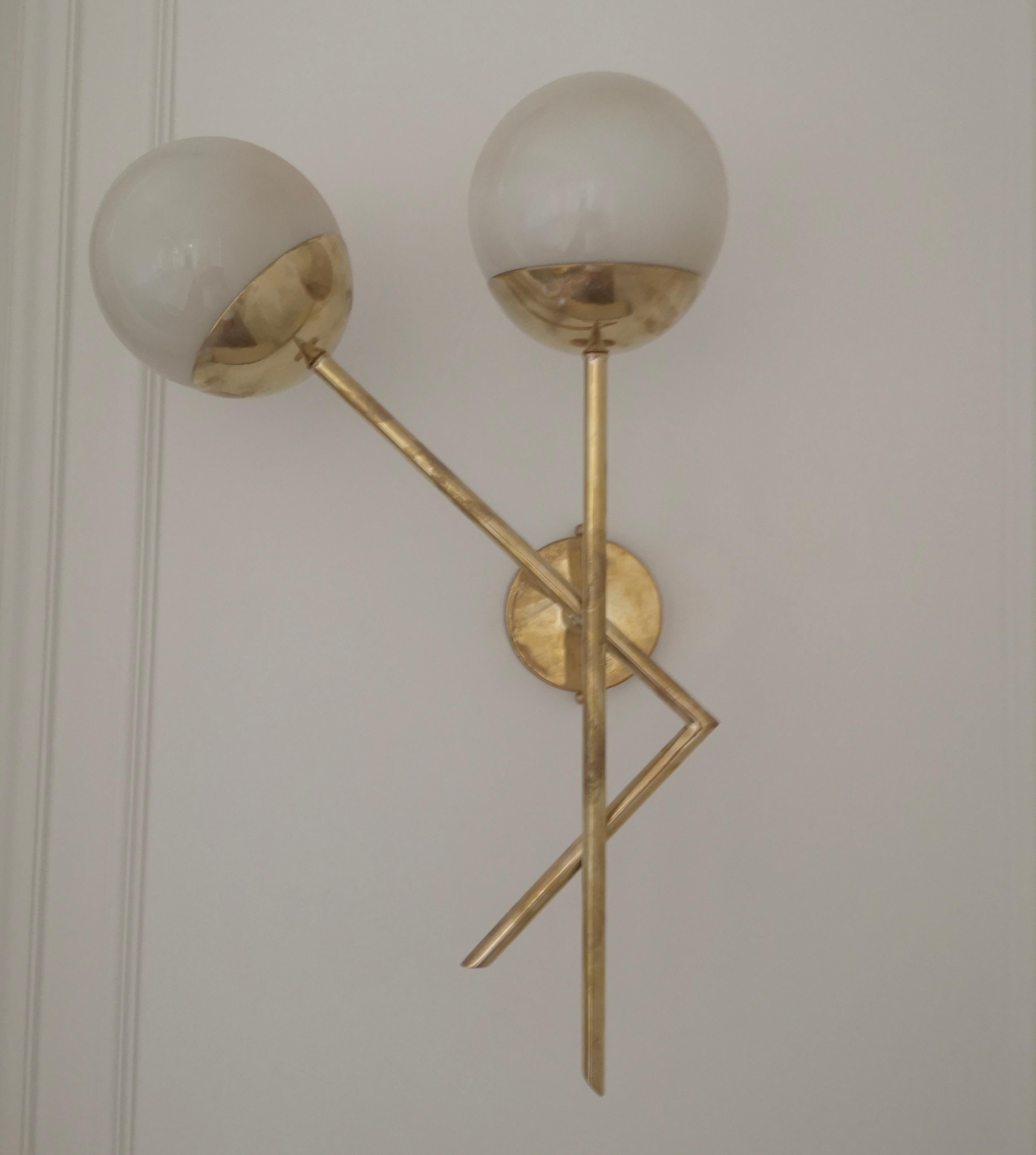 Refined and delicate design for this wall light with cream color Murano glass.

The applique are made up of a brass structure that allows the housing of a beautiful cream color Murano glass sphere. The design is very clean and simple, but at the