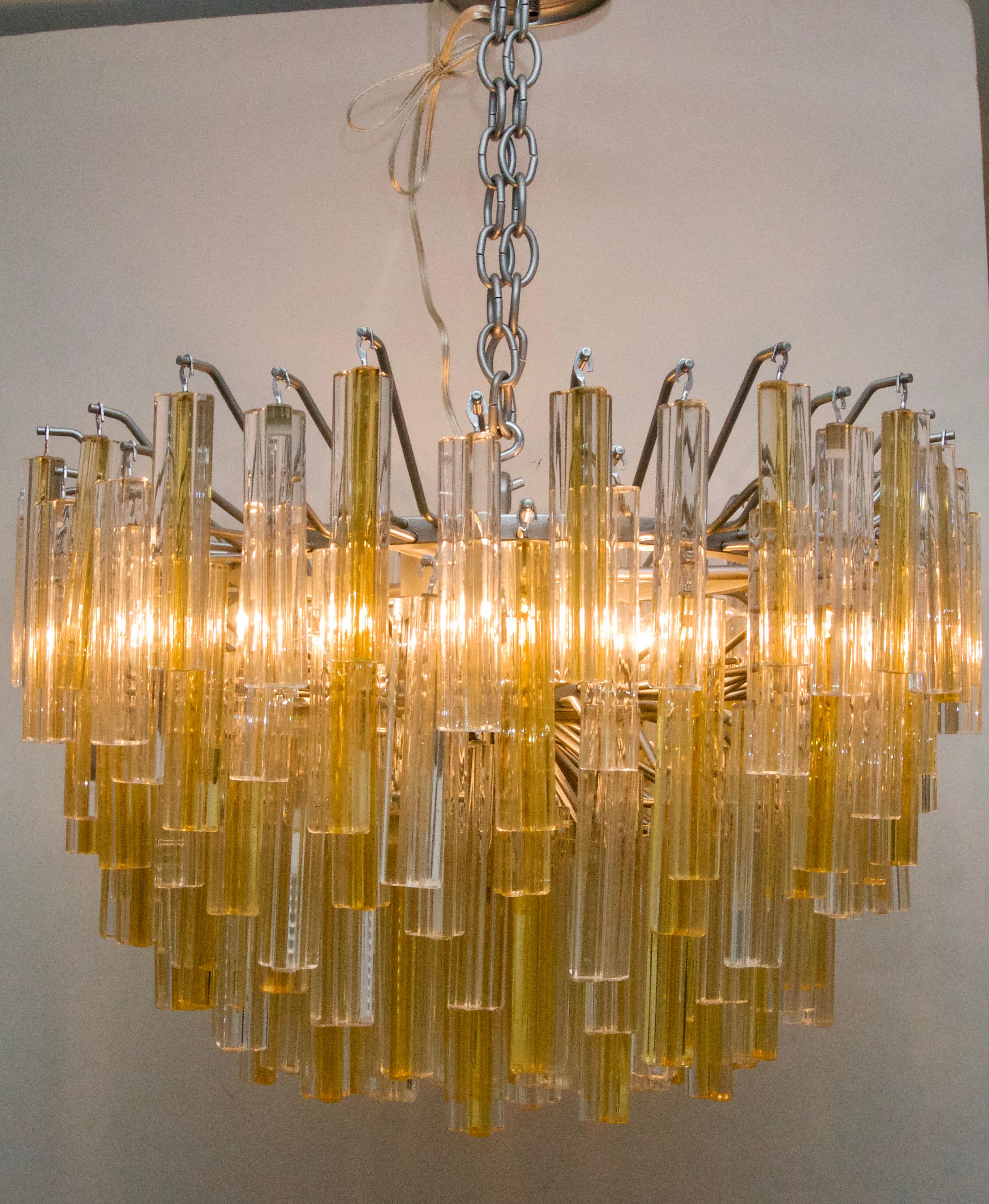 This stylish and chic Murano glass, Venini chandelier is one of the rarer color combinations of clear and golden yellow and the piece dates to the 1970s.

Note: The piece has been professionally rewired.

Note:  There is one missing gold prism.  The