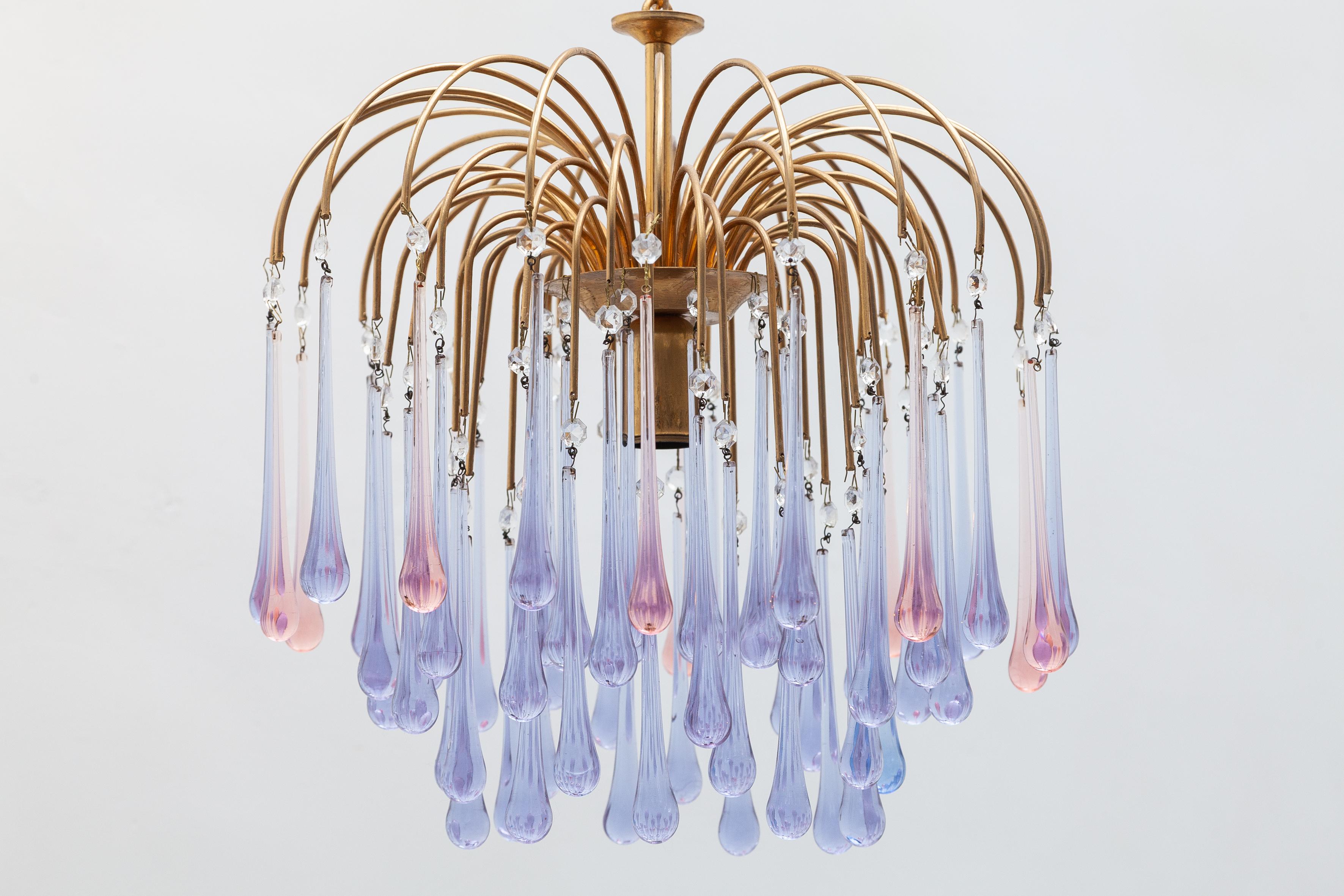 Glass teardrop 1970s chandelier designed by Venini, Murano. Bright brass frames suspend crystal drops in beautiful shades of
lavender, pink and smoked glass. Both lit by 1 bulb, Dimension: 44 W x 90 H x 44 D cm 

One smaller chandelier available.