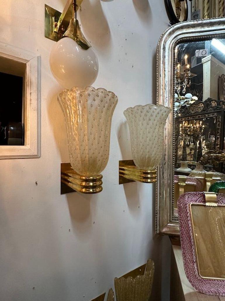 Nice pair of modern Murano glass and brass cup sconces. Circa 2000. The sconces have been professionally rewired and ready to hang.