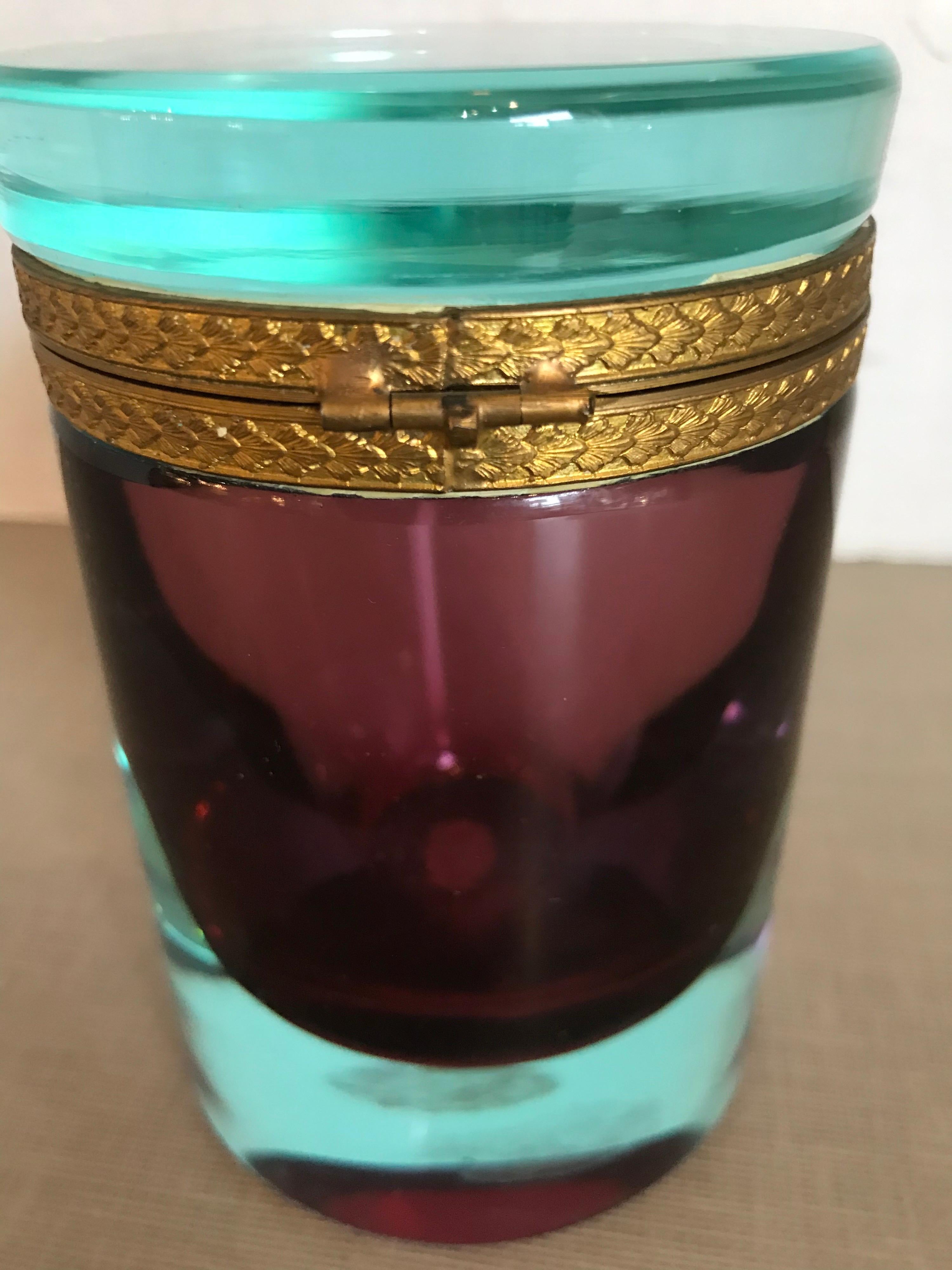 This is a heavy bi-colored turquoise and purple Murano glass cylinder box with brass ormolu rim probably from 1950s-1960s great condition.