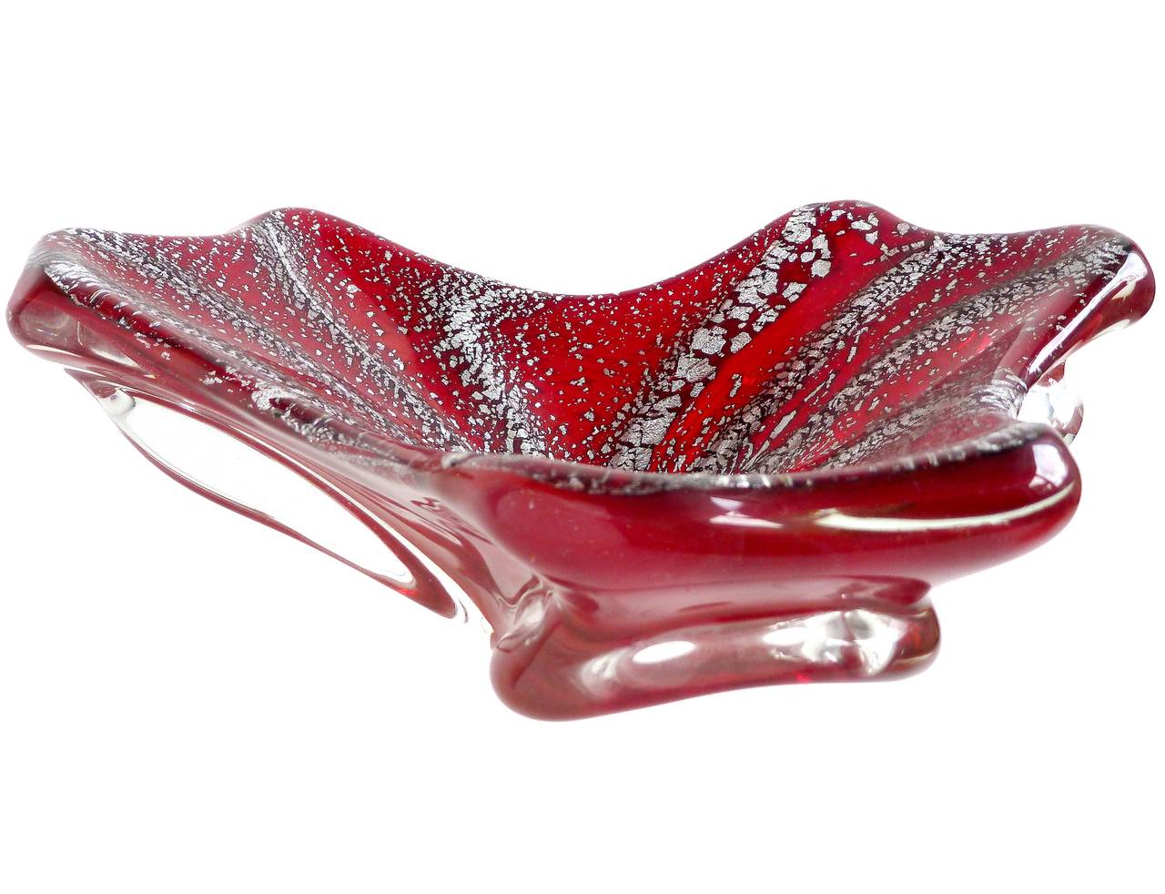 Beautiful Murano hand blown red and silver flecks Italian art glass biomorphic bowl. The piece is cased over with clear glass, and pulled from underneath to create the shape. It has very heavy silver leaf throughout in a spiral pattern. A statement