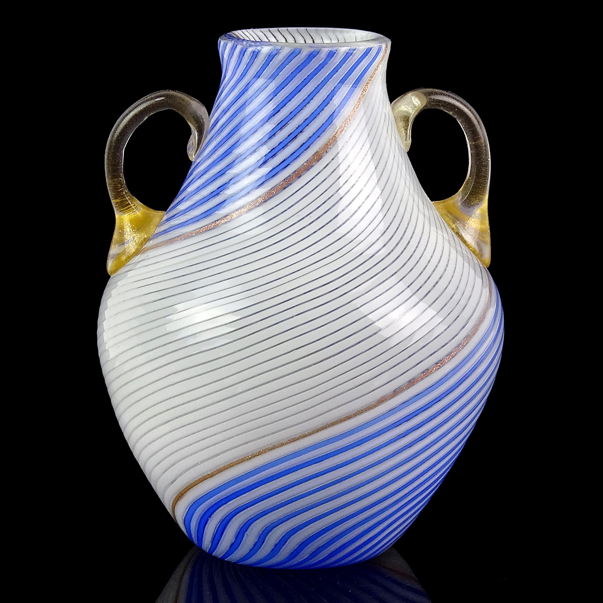 Beautiful vintage Murano hand blown white and blue ribbons Italian art glass flower vase. The piece is documented to designer Dino Martens, for the Aureliano Toso workshop. The vase is created in a “Mezza Filigrana” with a line of glittery copper