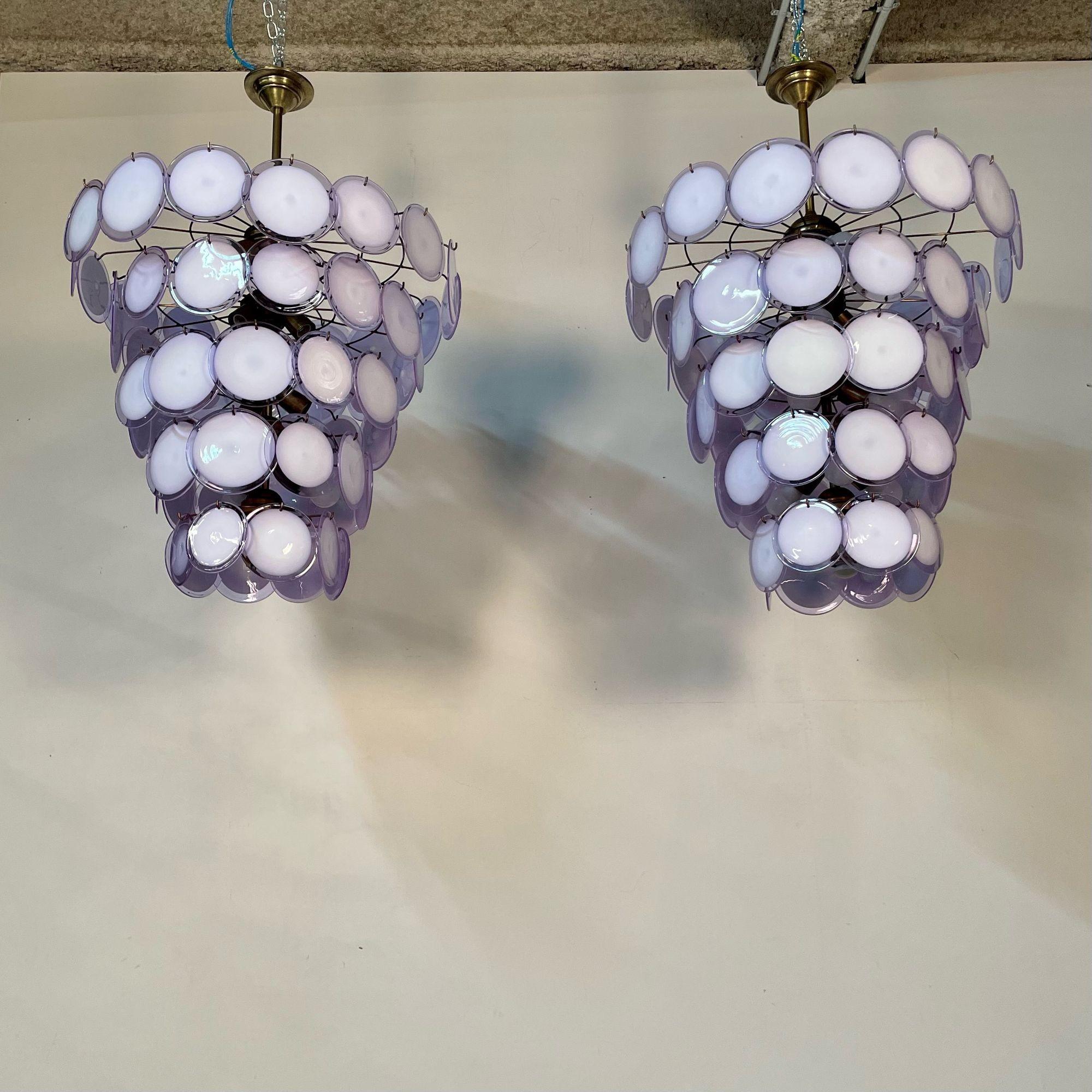 Murano Disc Mid-Century Modern Tiered Chandelier, Antiqued Brass, New Wired, Lavender and White Disk. 
 
After purchasing a small factory of circa 1950/60s Murano Discs in Italy we have started to manufacture our own 2020 frames. These frame made