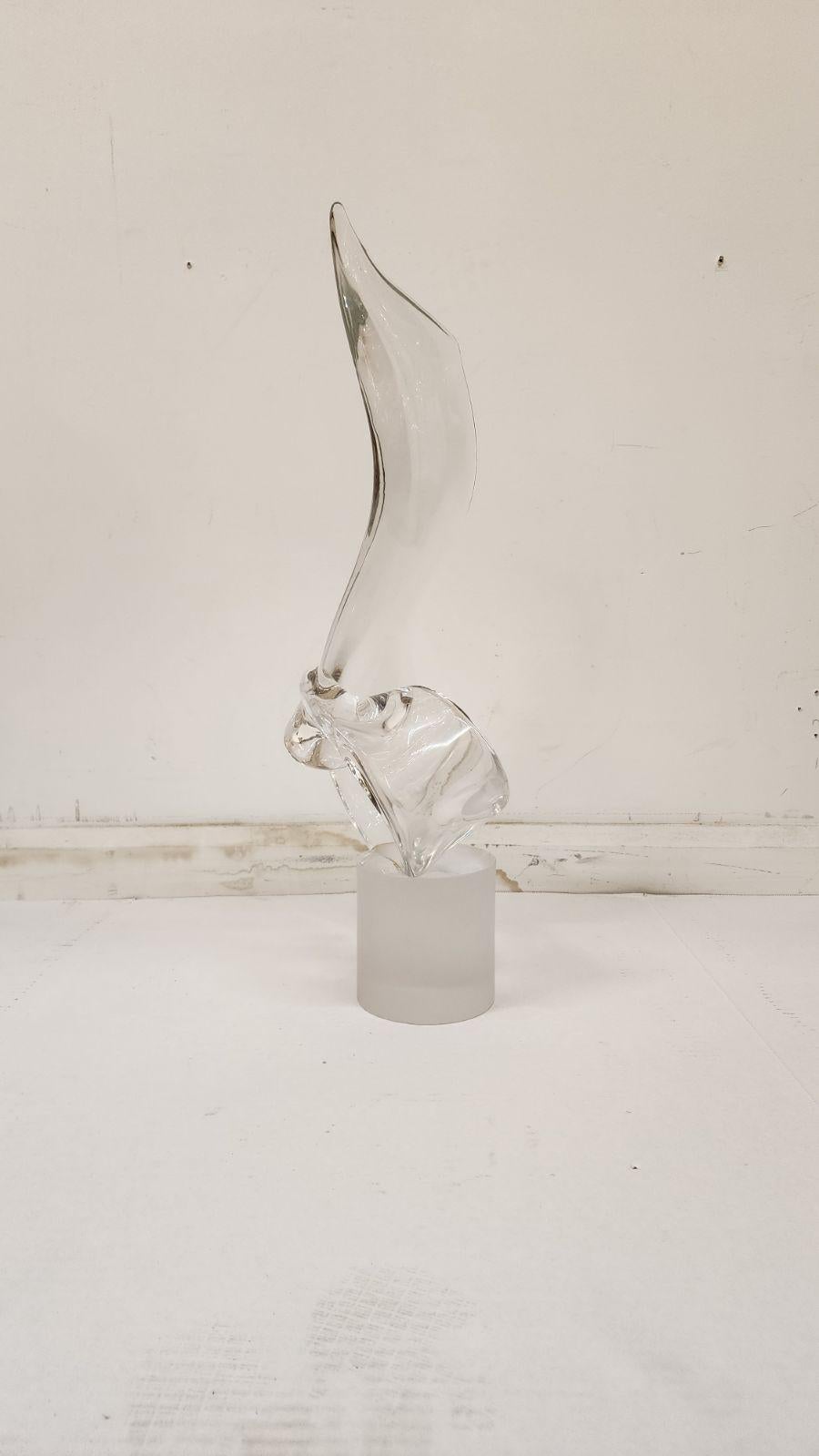 Murano Statue in the manner of Elio Raffaeli. Crafted of clear Italian art glass. Depicting an abstract scrolling wave form. Surmounting a frosted cylindrical base. 