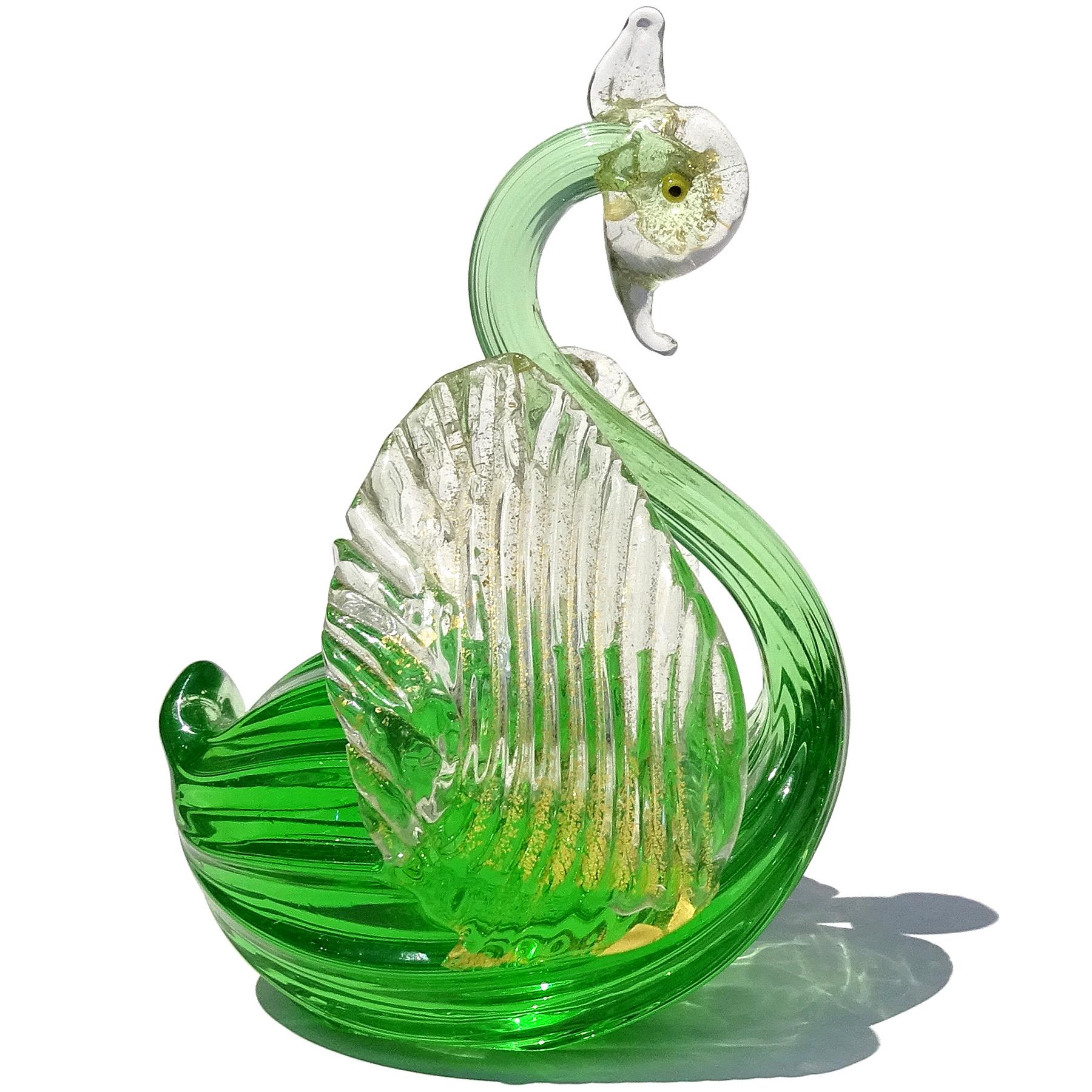 Beautiful vintage Murano hand blown emerald green and gold flecks Italian art glass swan sculpture / figurine. The bird has a long thin neck with outstretched wings. The eyes are made with little yellow and black canes. The head and wings are filled