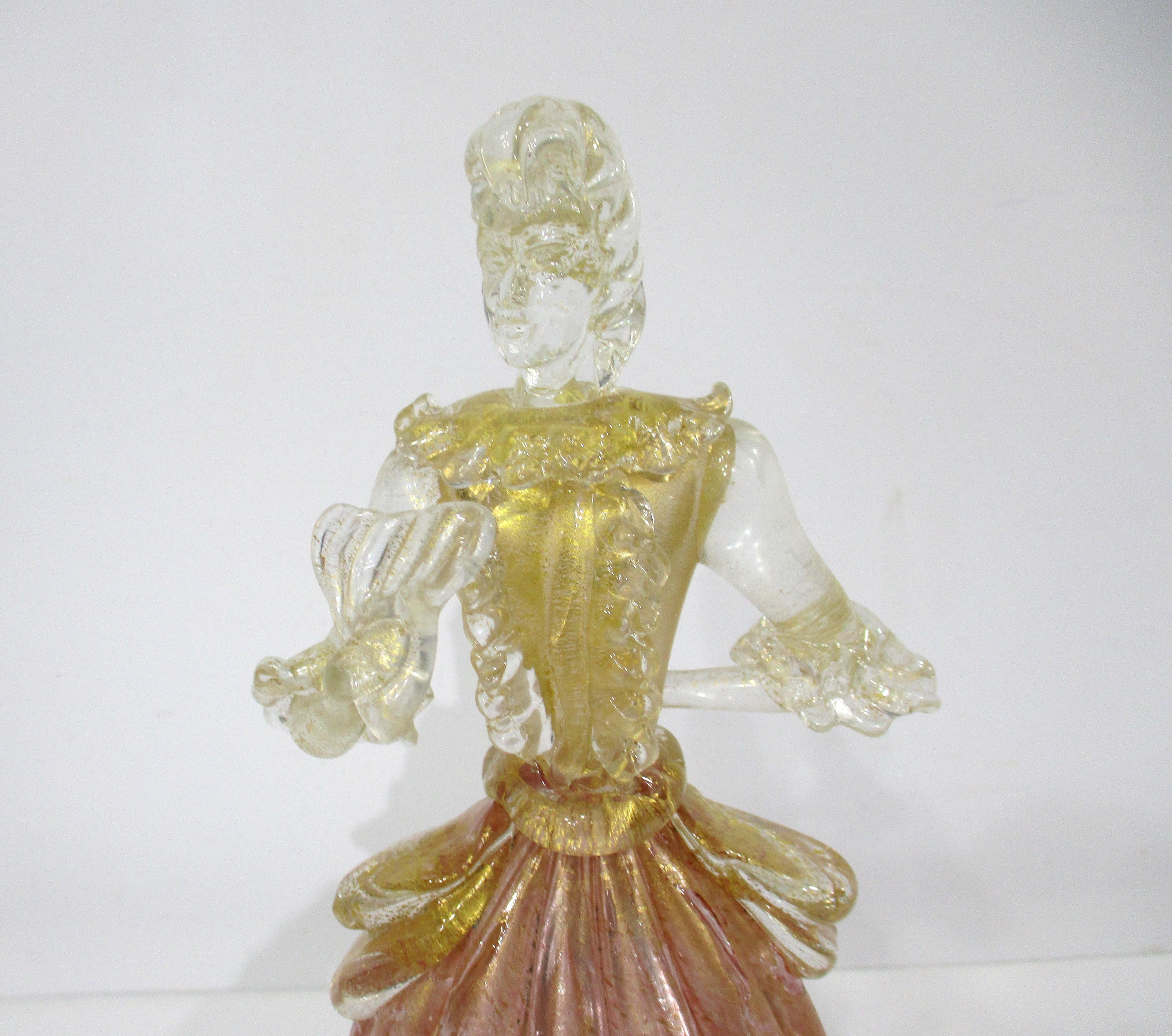 A very fine handcrafted blown Murano art glass female figurine with gold and toned flecks . This classic looking form is of a lady in waiting with Baroque overtones made in Italy in the manner of Seguso Vetri d'Arte . 
 