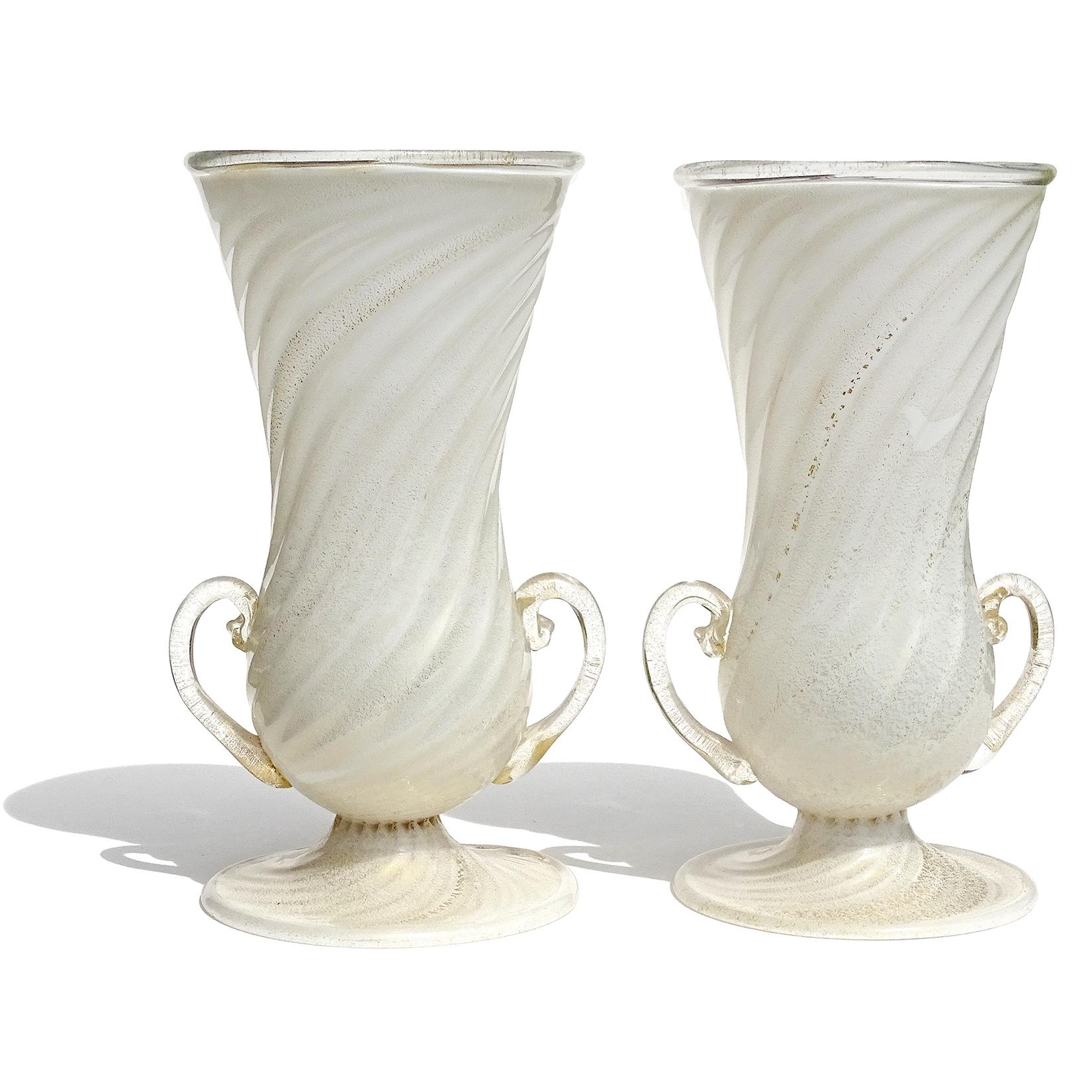 Beautiful and rare, matching antique Murano hand blown white and gold flecks Italian art glass double handles flower vases. Documented to the Ferro Toso Barovier Vetreria Artistiche Riunite S. A. company, circa 1939-1942. One of the vases still